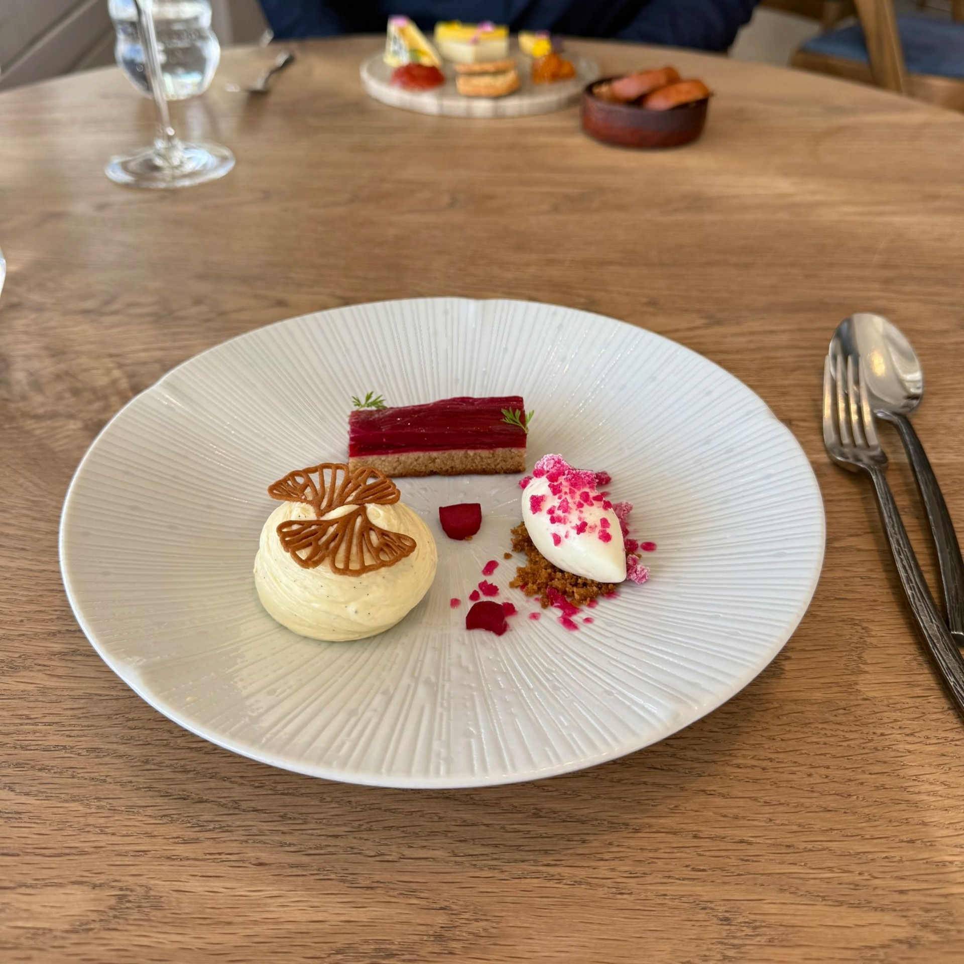 Elegant rhubarb tart with cheesecake elements and ice cream at The Waterside.