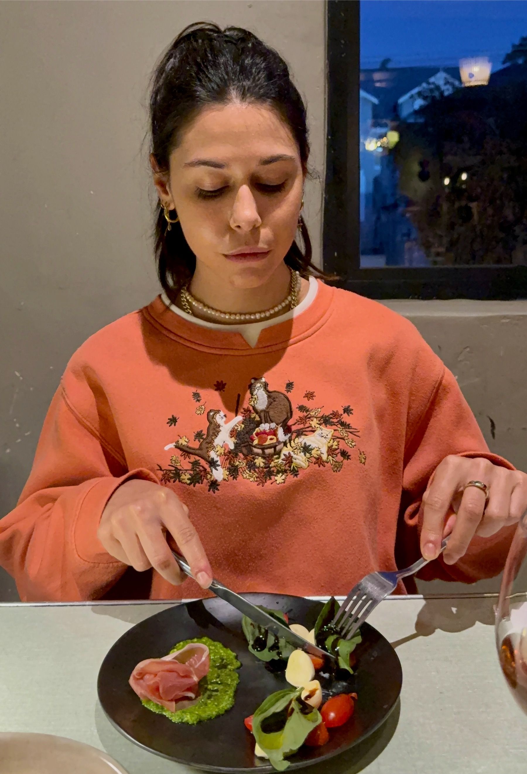 Paige cutting into a caprese and Parma ham starter at The Woodlands Eatery wine pairing
