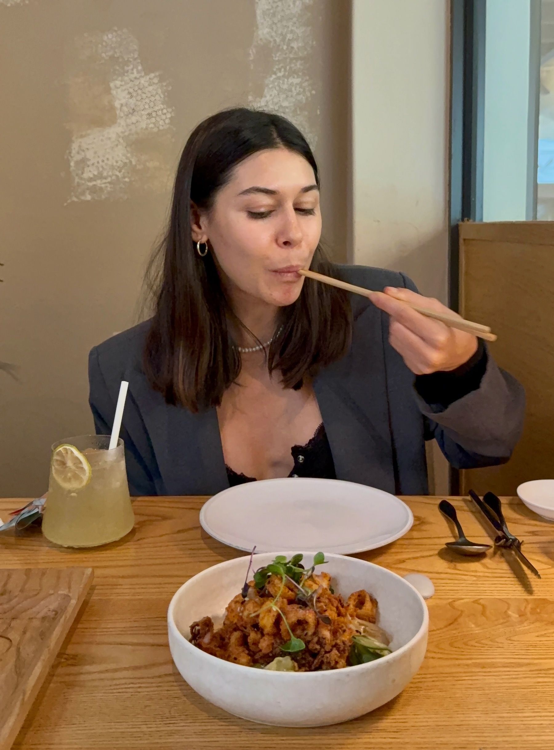 Paige tasting crispy fried calamari at Yama restaurant Cape Town