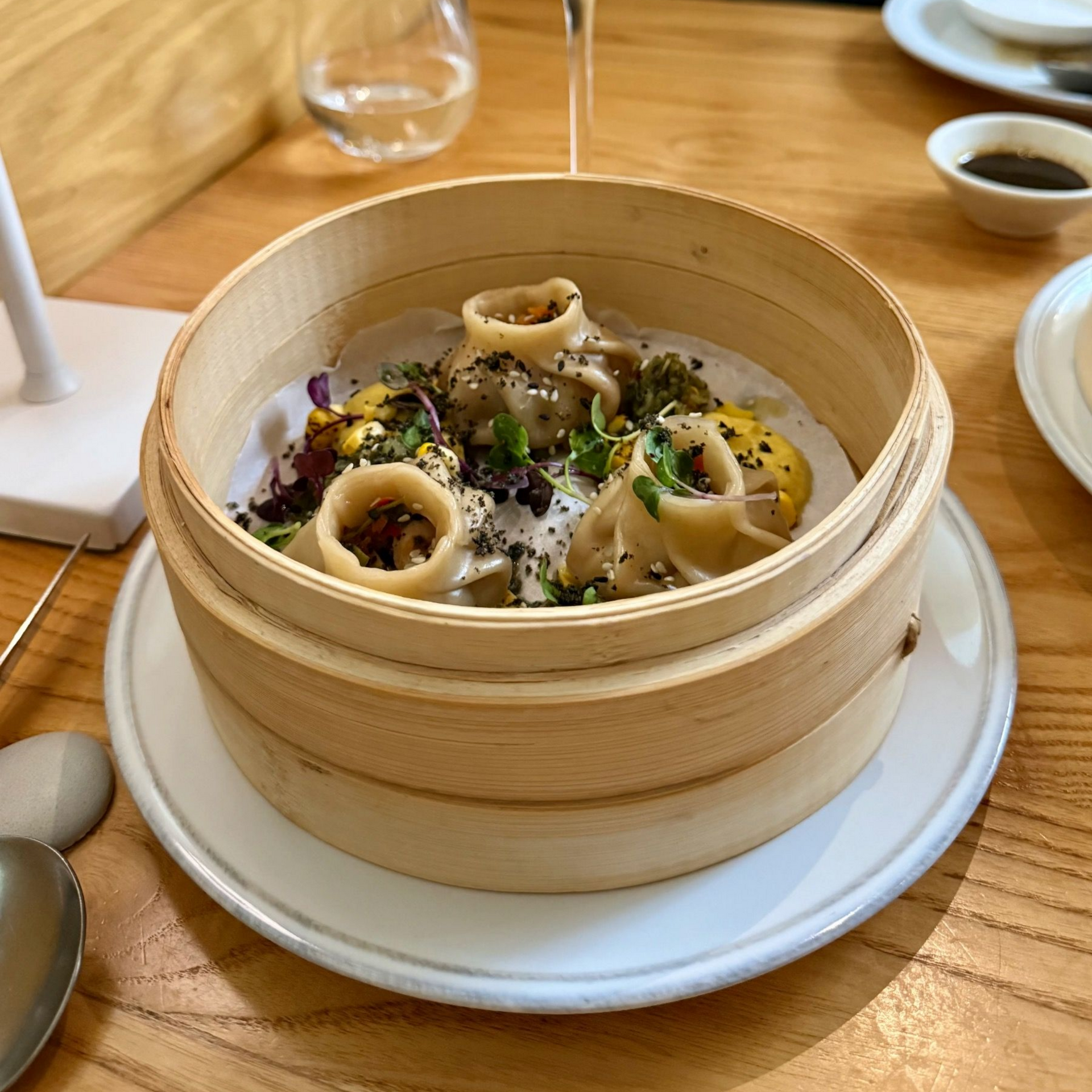 Steamed dumplings in bamboo basket at Yama Asian restaurant Cape Town
