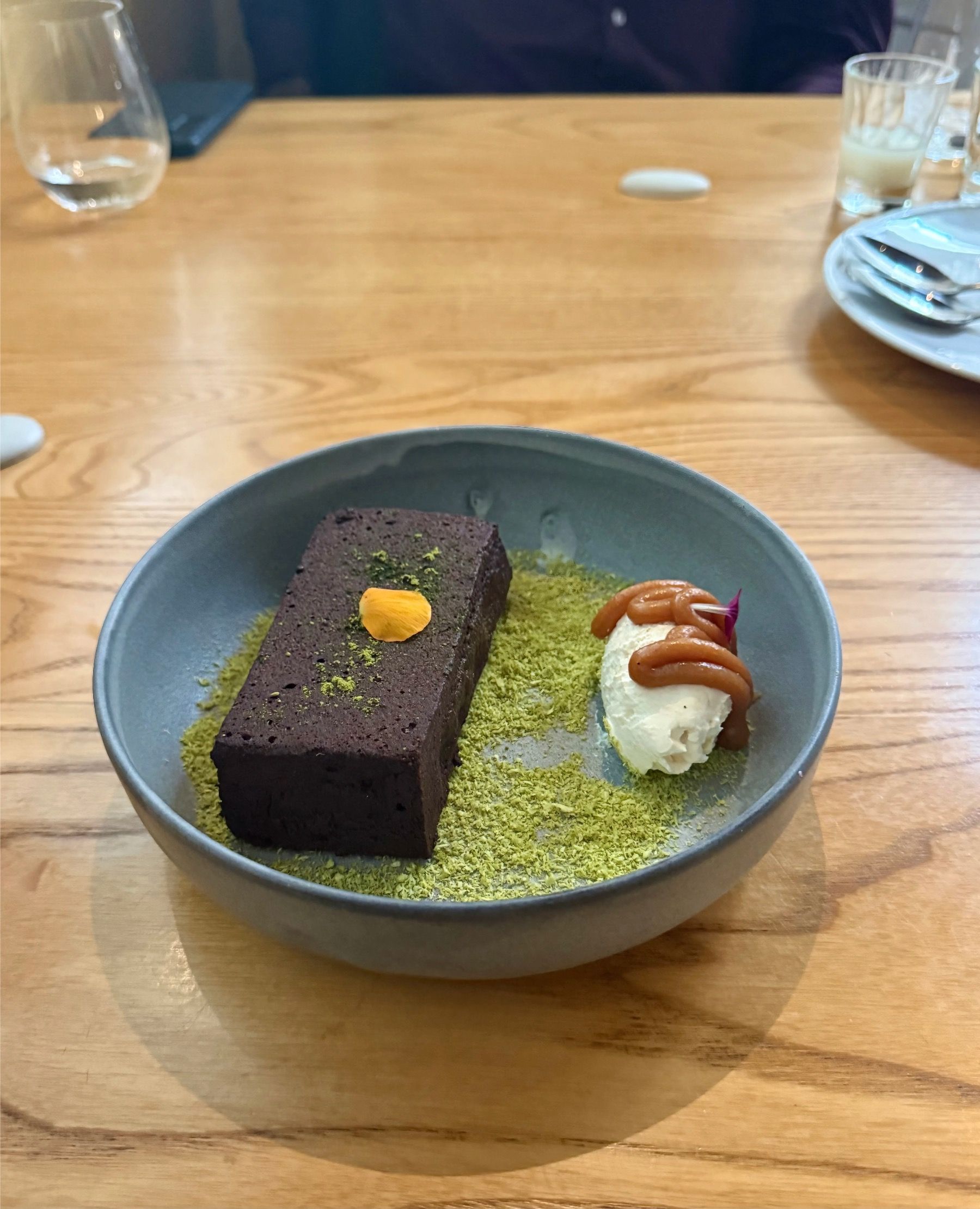 Chocolate brownie dessert with cream and garnish at Yama Cape Town