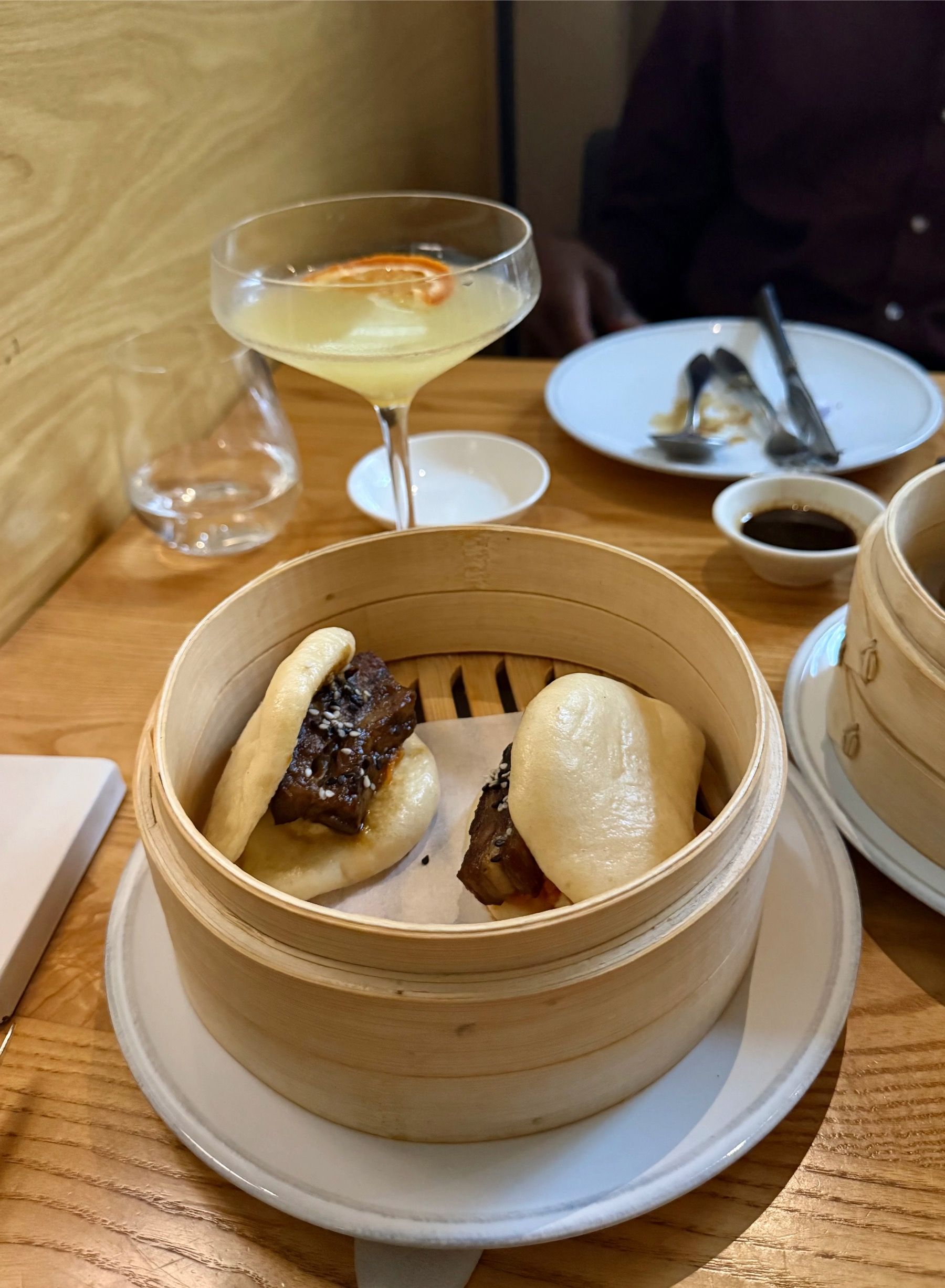 Steamed bao buns served in bamboo basket at Yama Asian Eatery