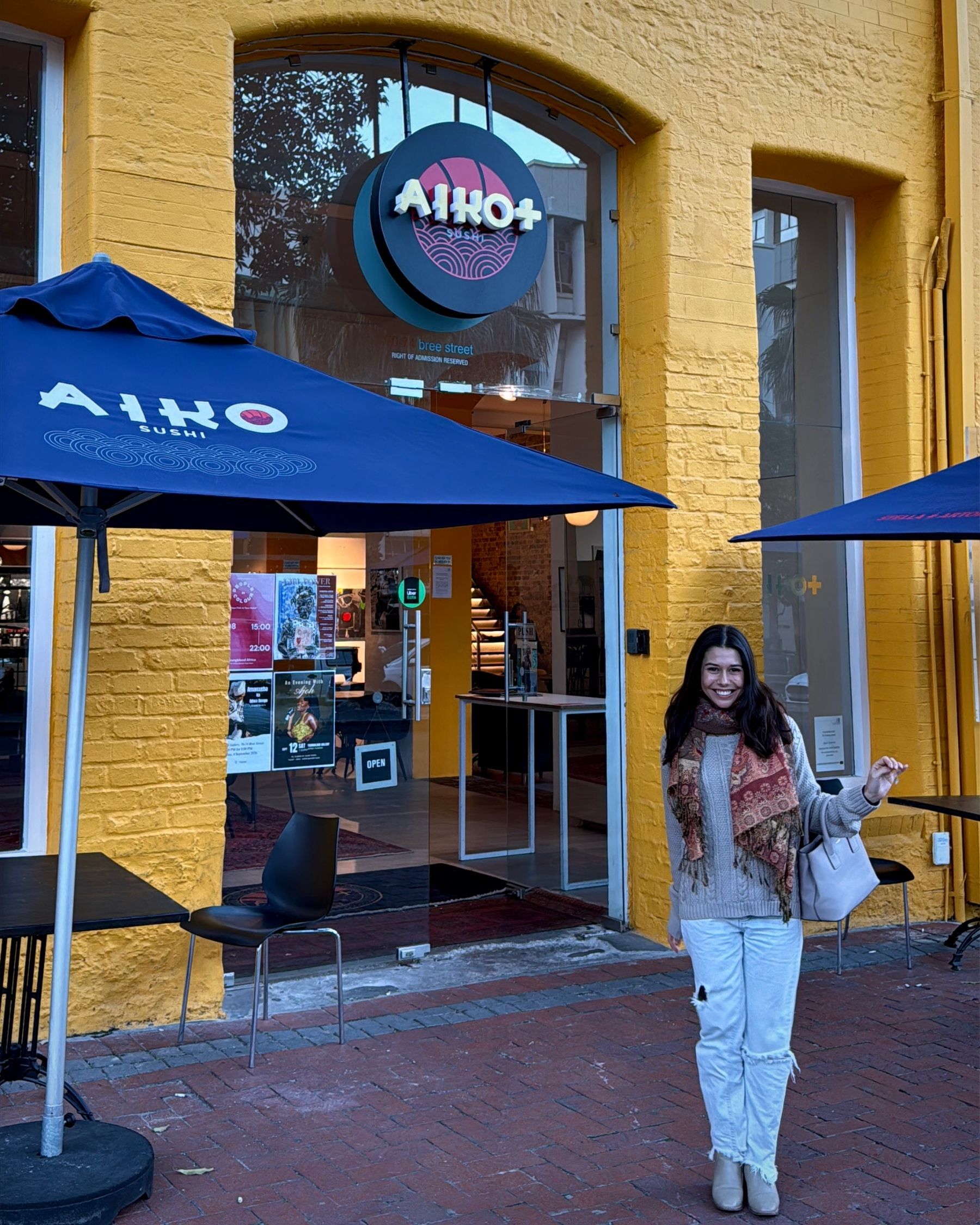 Paige standing outside the Mischu sign in Sea Point, Cape Town.