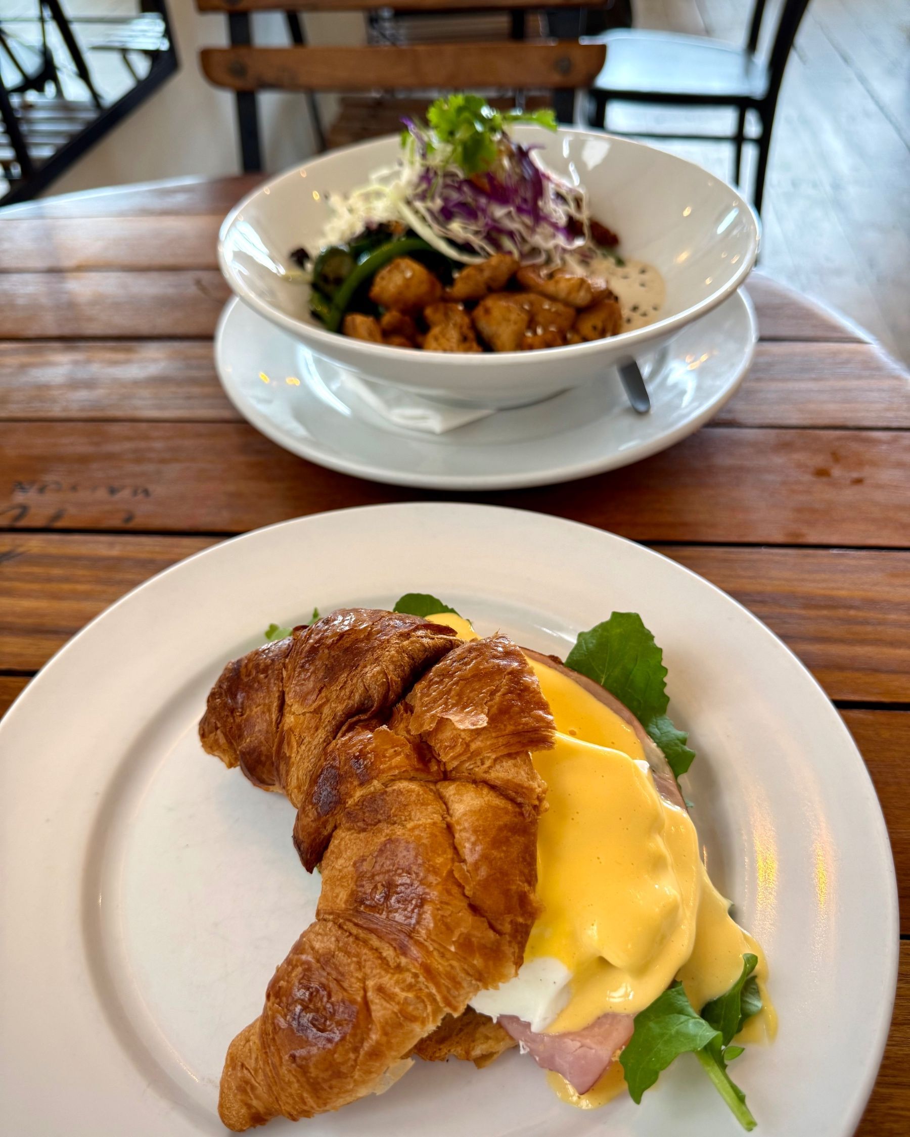 Croissant Eggs Benedict in the foreground with the Chicken Bowl in the background at Dalebrook Café.