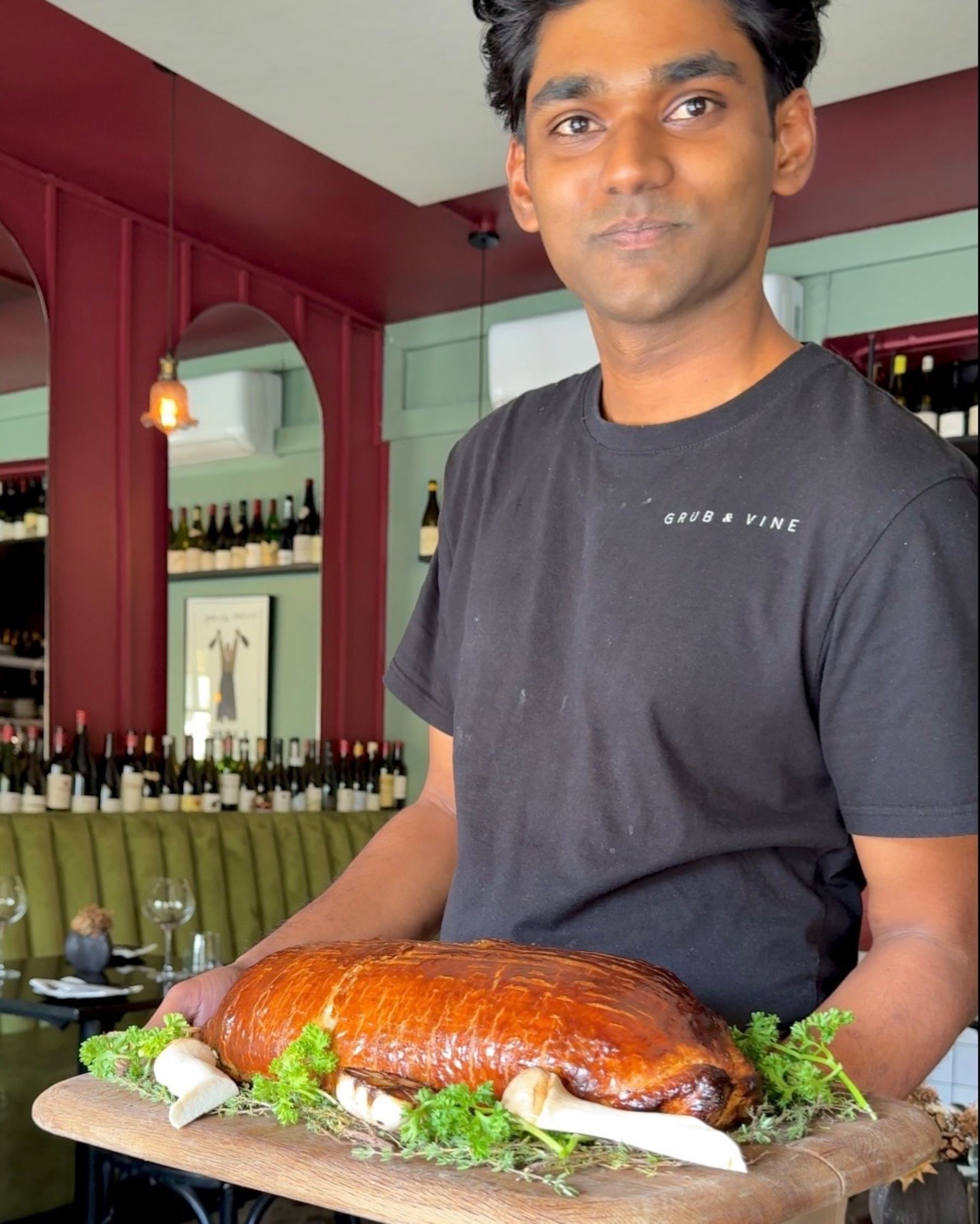 Chef presenting the signature Beef Wellington at Grub & Vine.