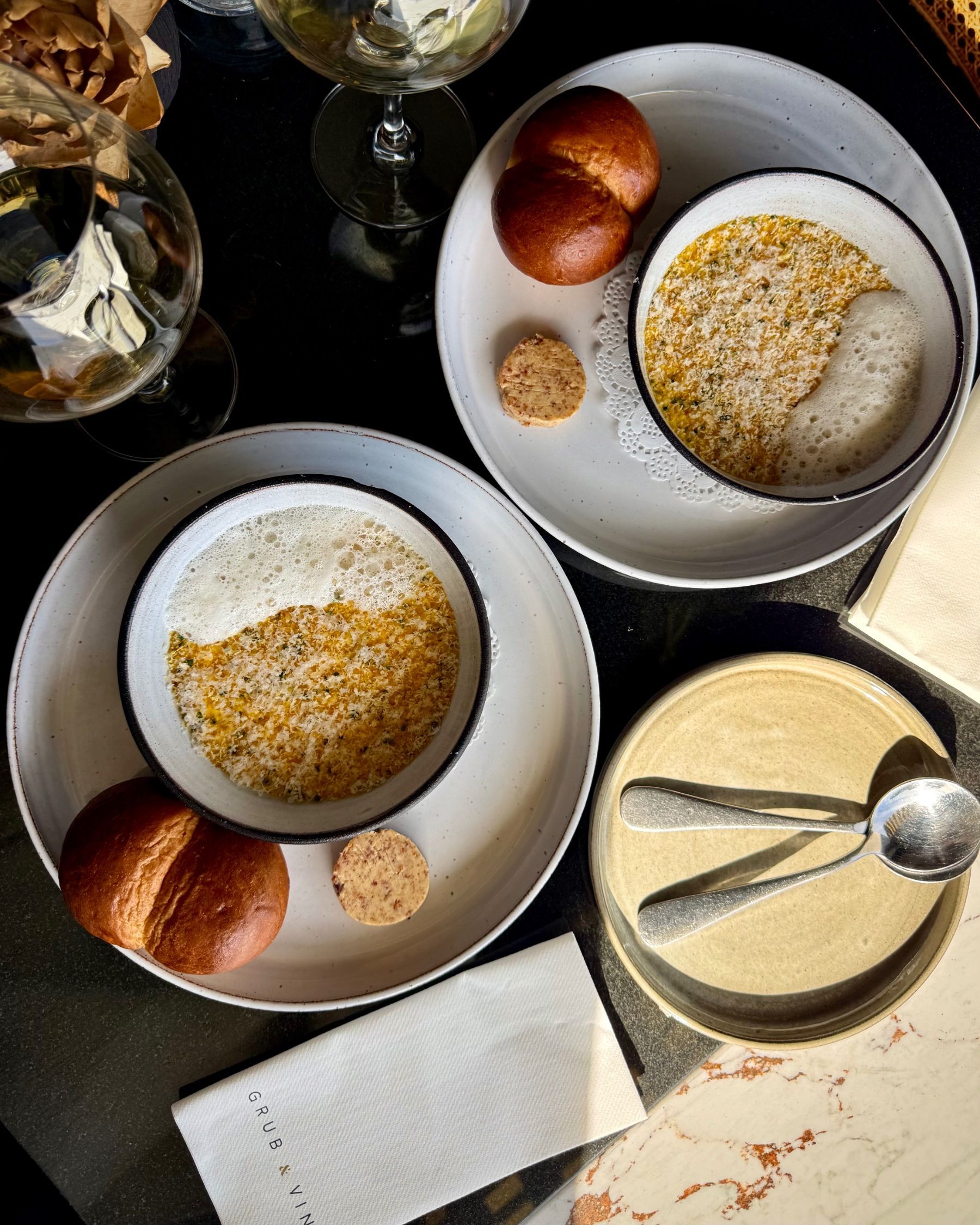 Close-up of the carrot and Parmesan soup with brioche and bacon butter.