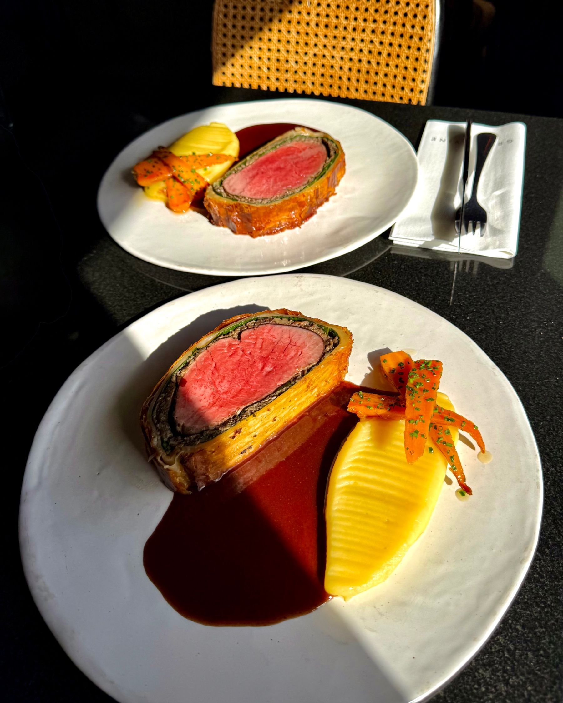 Beef Wellington served with seasonal accompaniments at Grub & Vine.