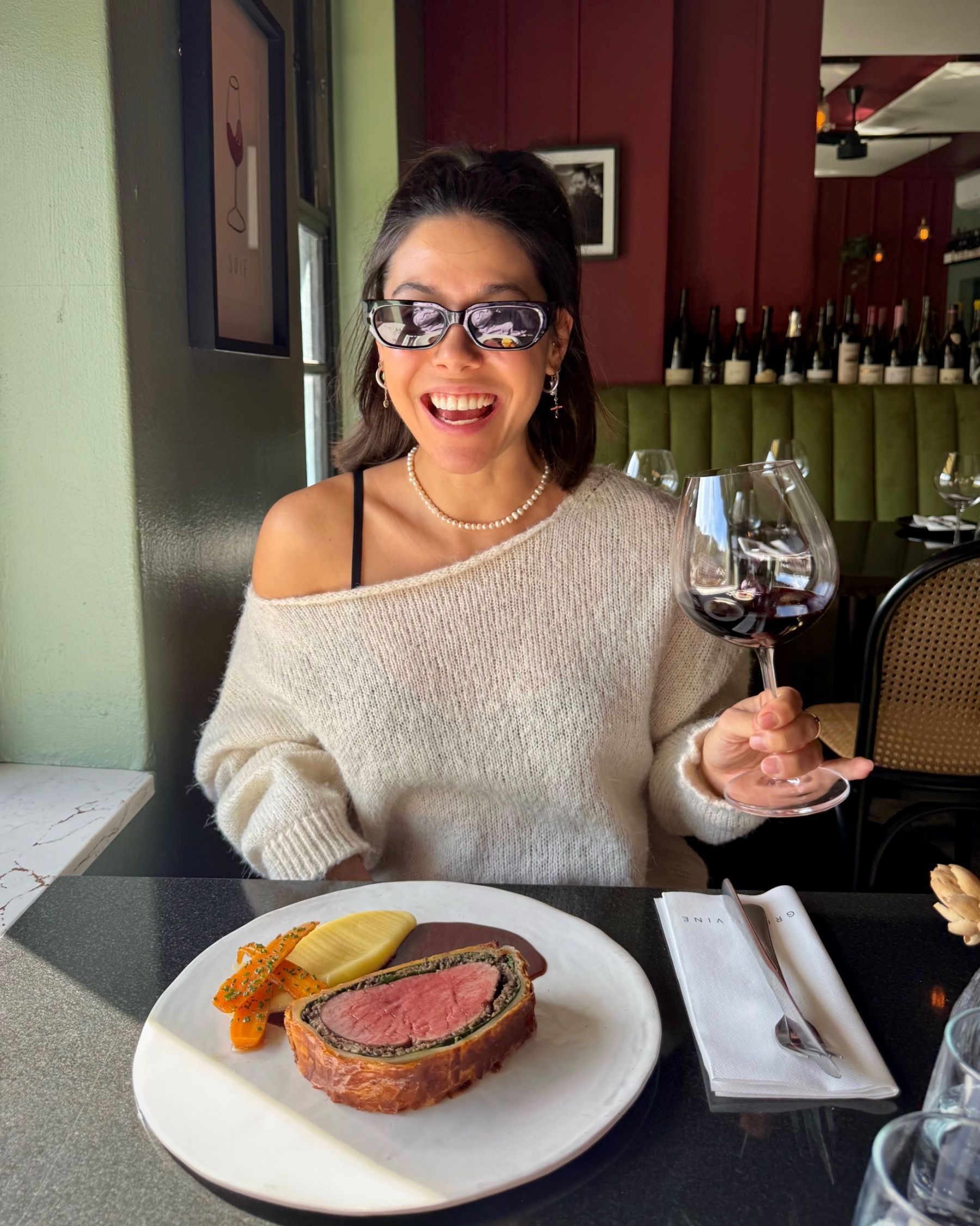 Paige wearing sunglasses before tasting the Beef Wellington.