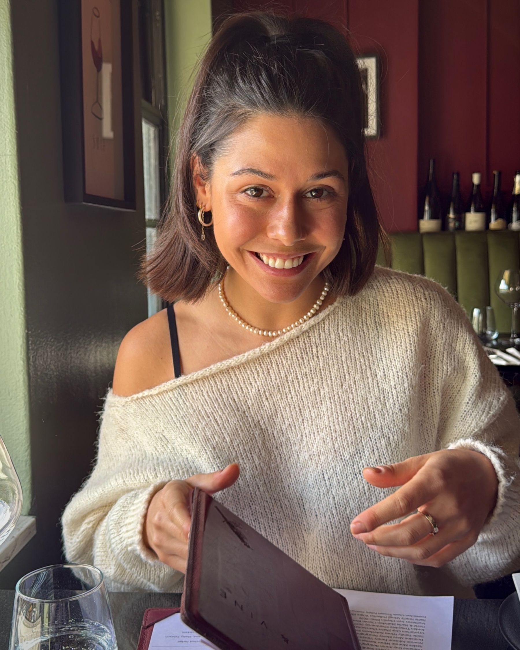 Paige reading the menu at Grub & Vine before lunch.