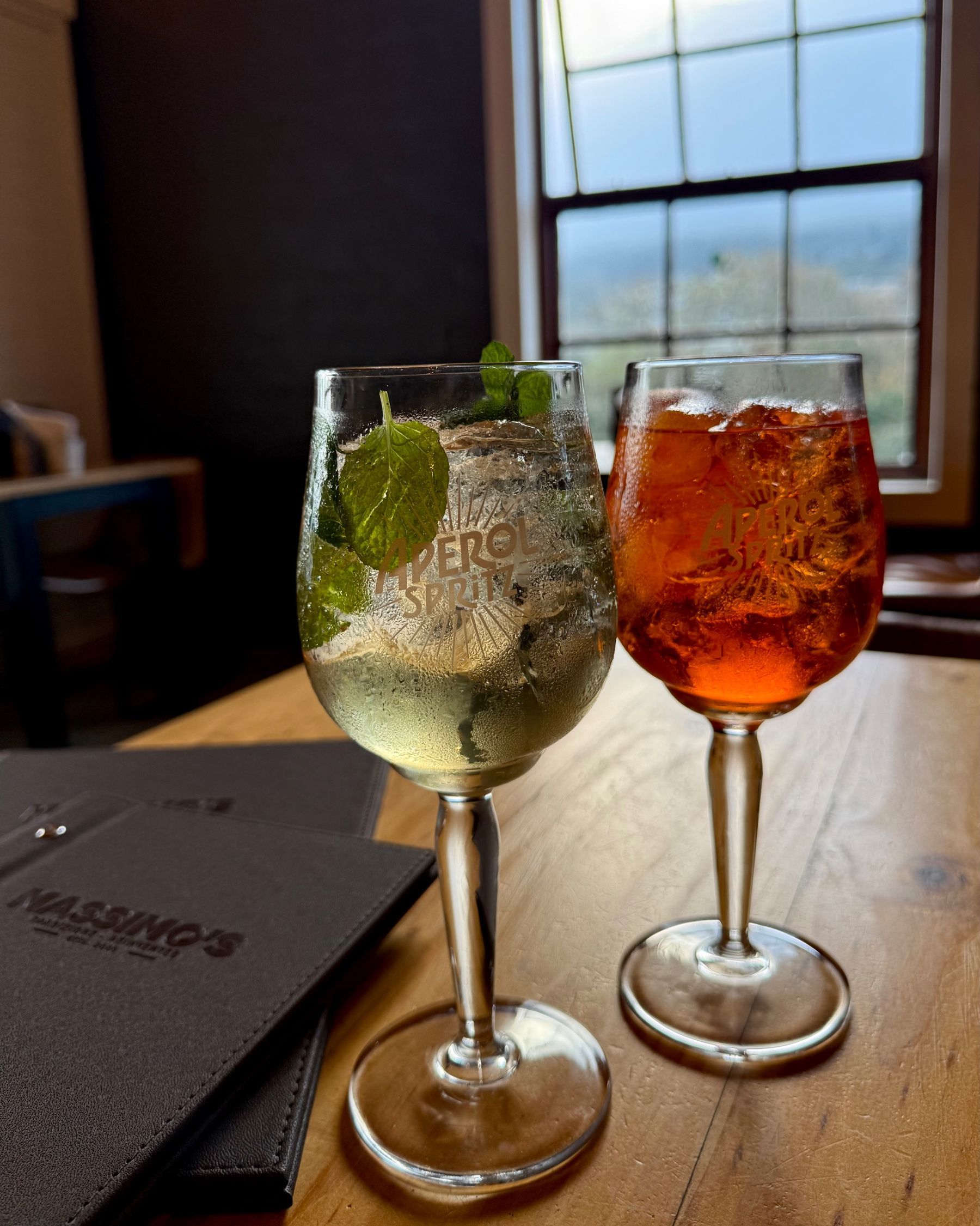 A Hugo Spritz and an Aperol Spritz served side by side.

