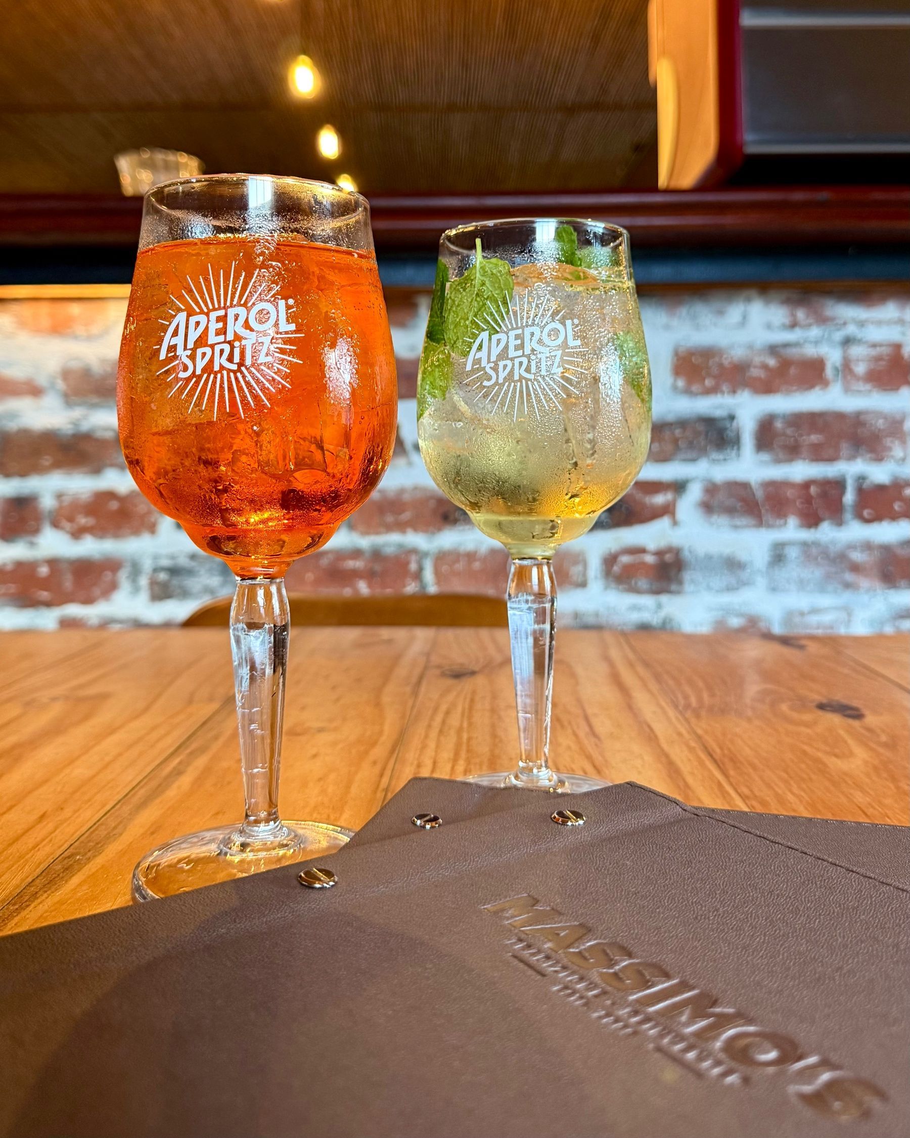 A Hugo Spritz and an Aperol Spritz served side by side.

