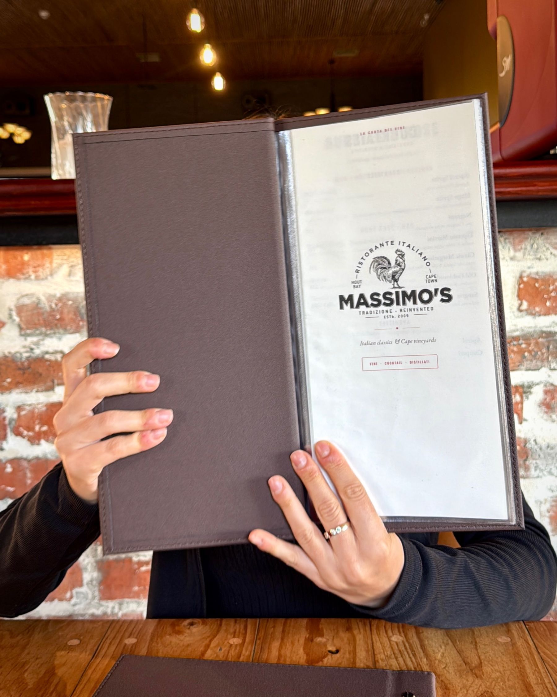 Paige holding the Massimo’s menu in front of her face.

