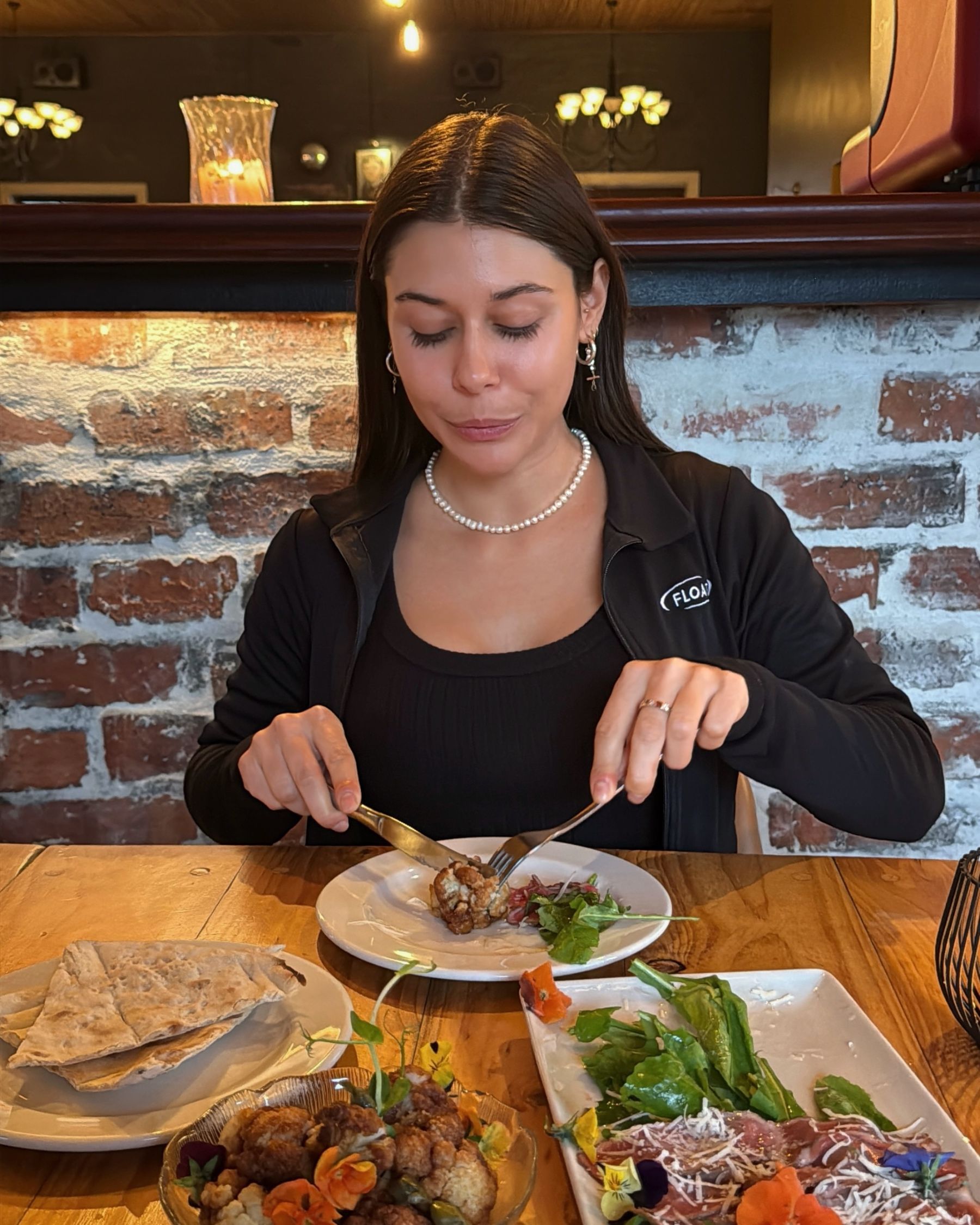 Paige enjoying the vegan cauliflower dish.
