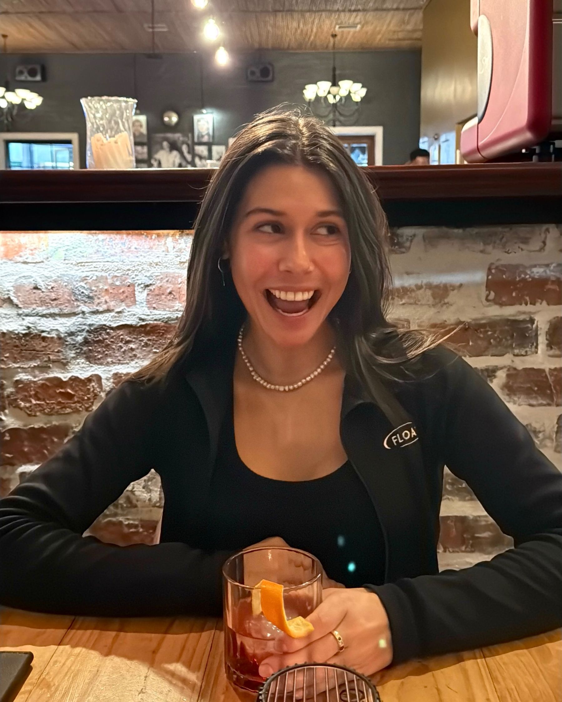 Paige sipping a Negroni while dining at Massimo’s.
