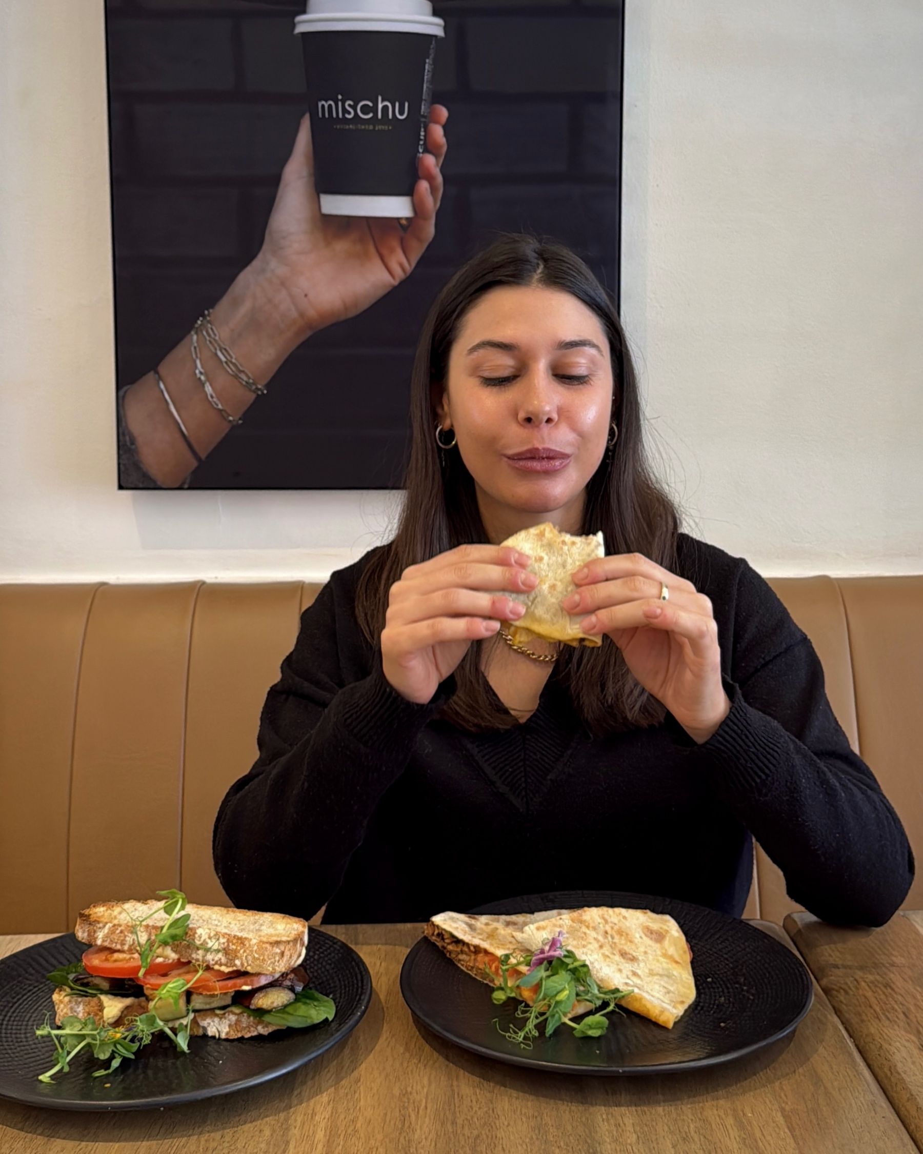 Paige eating the Pulled Beef Flatbread at Mischu in Sea Point.