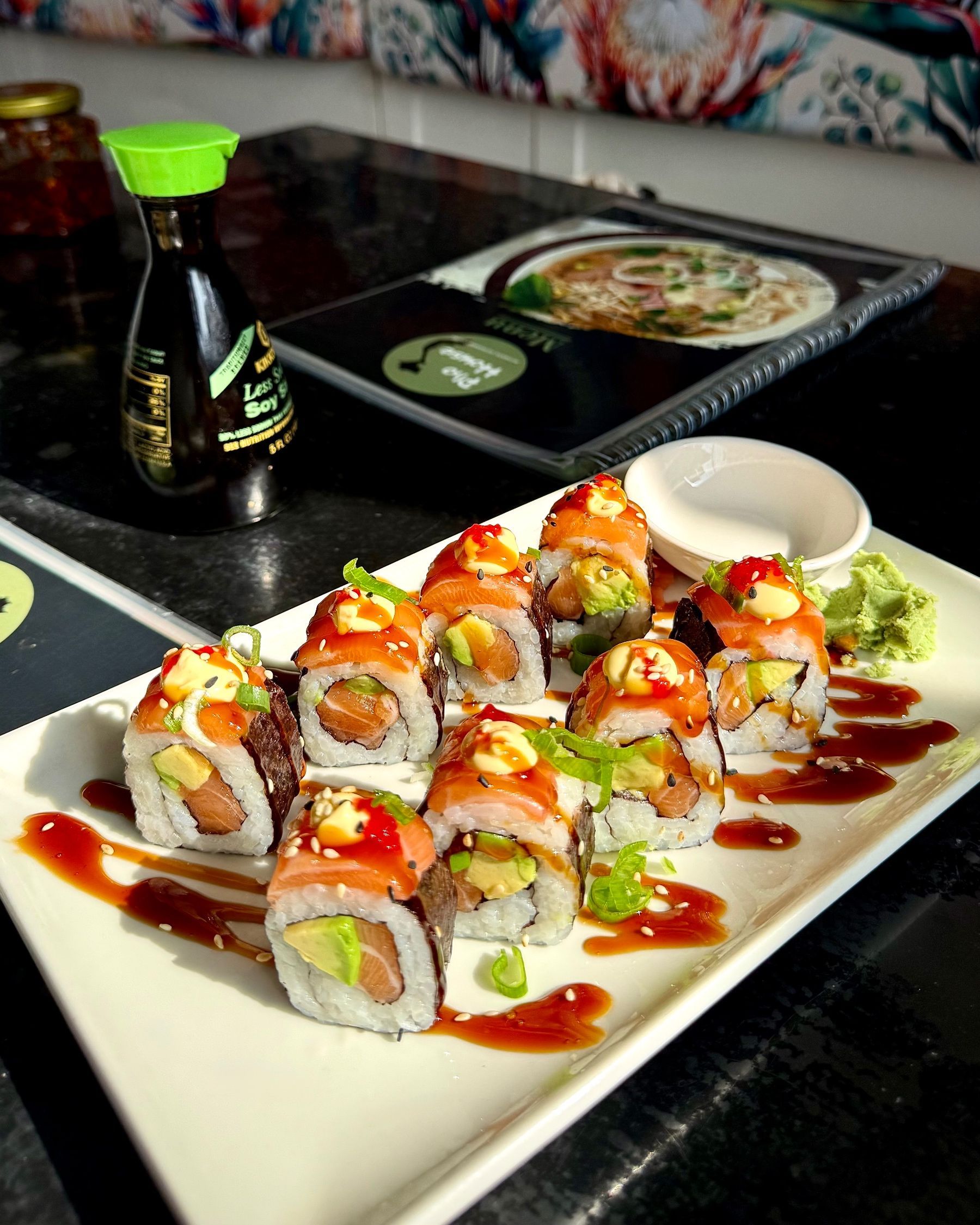 Paige standing next to the Dalebrook Café entrance sign in Kalk Bay.
