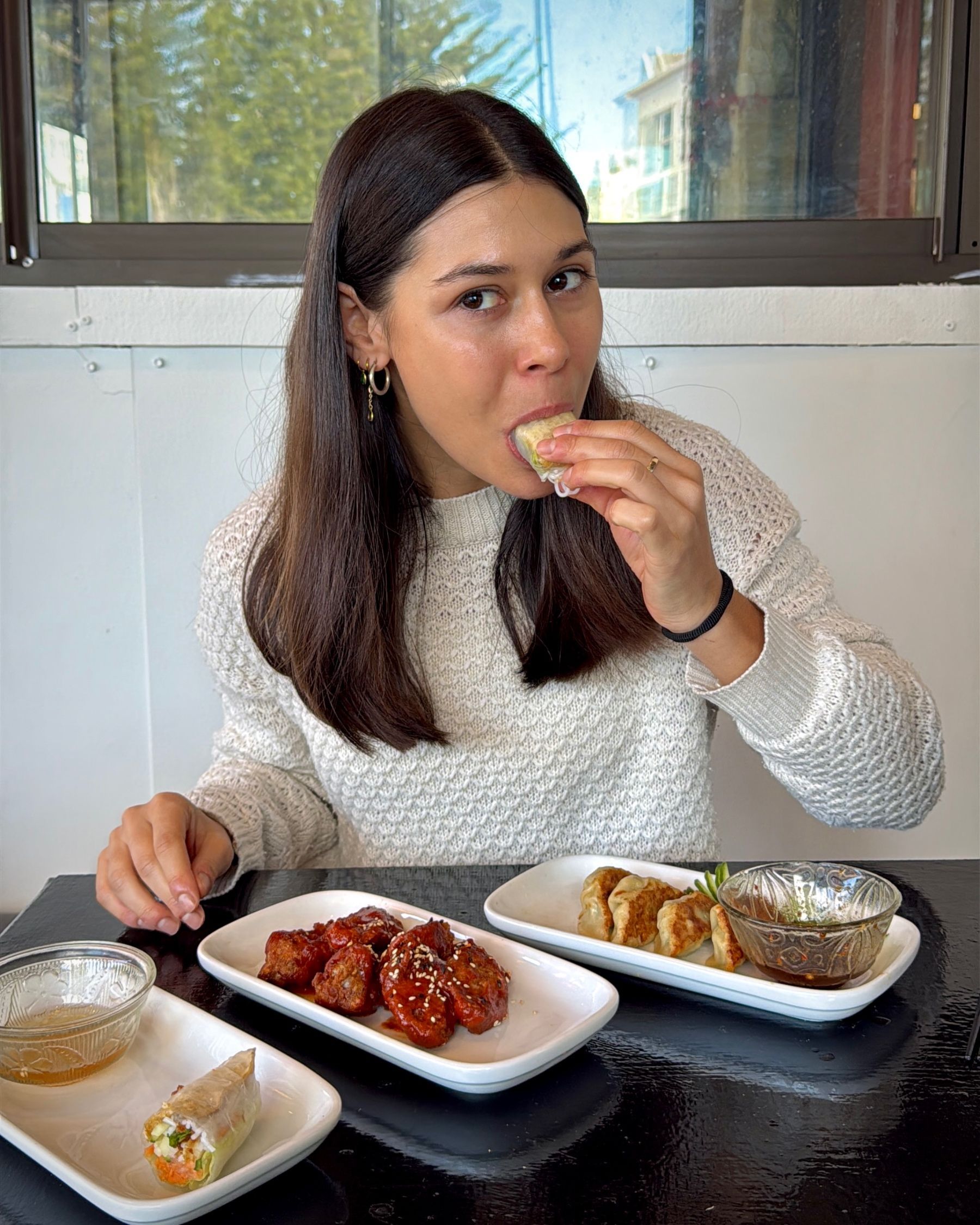 Paige enjoying a fresh Vietnamese spring roll at Pho Hue.