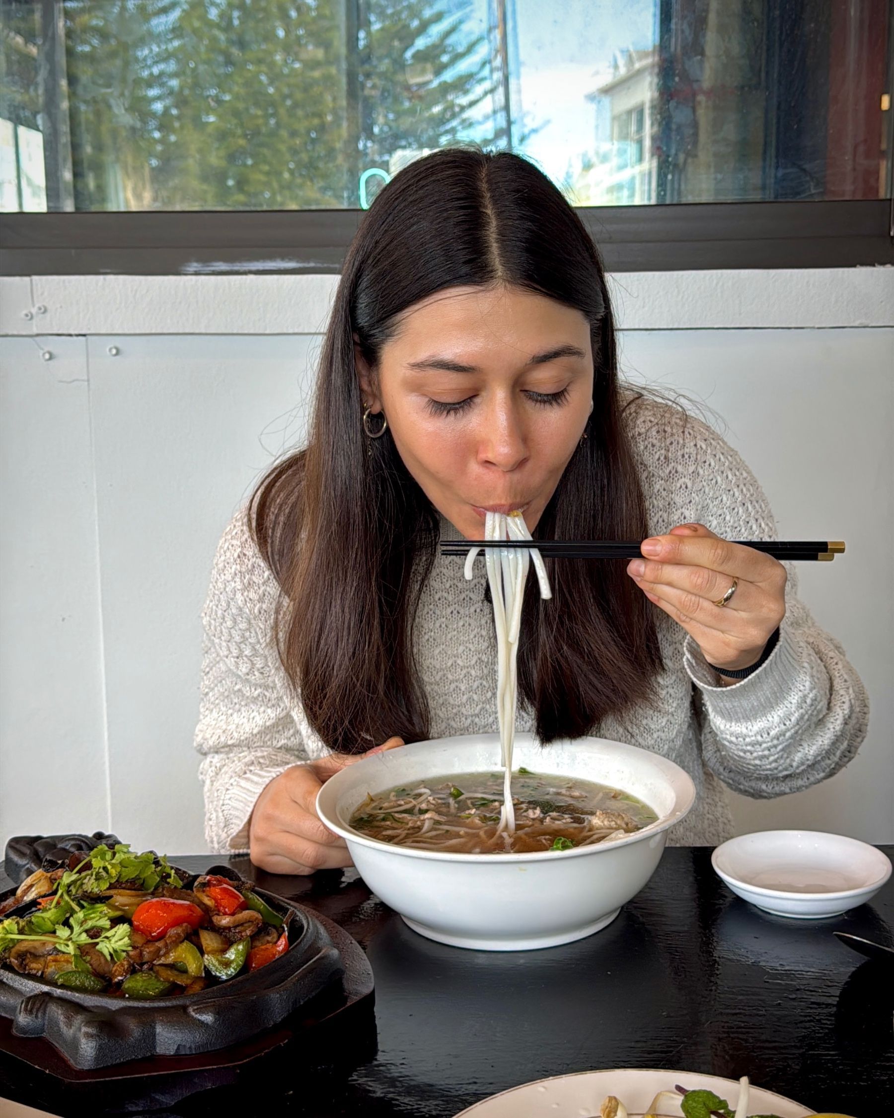 Paige enjoying a bowl of traditional beef pho at Pho Hue.