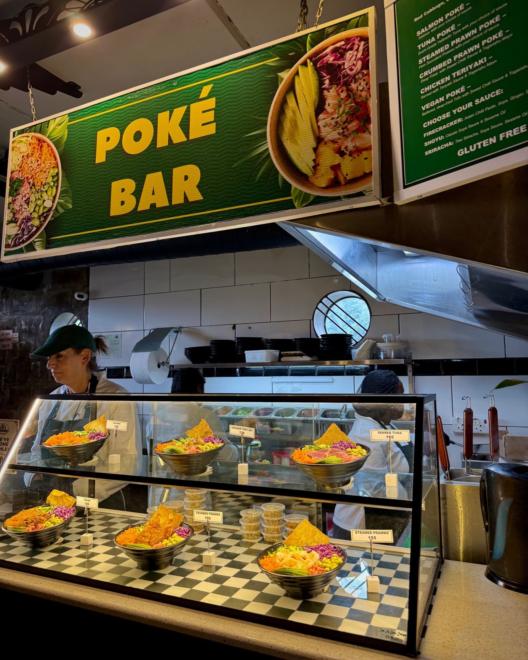 A table filled with Vietnamese dishes from Pho House, including pho, vermicelli, bánh mì, spring rolls and sushi.