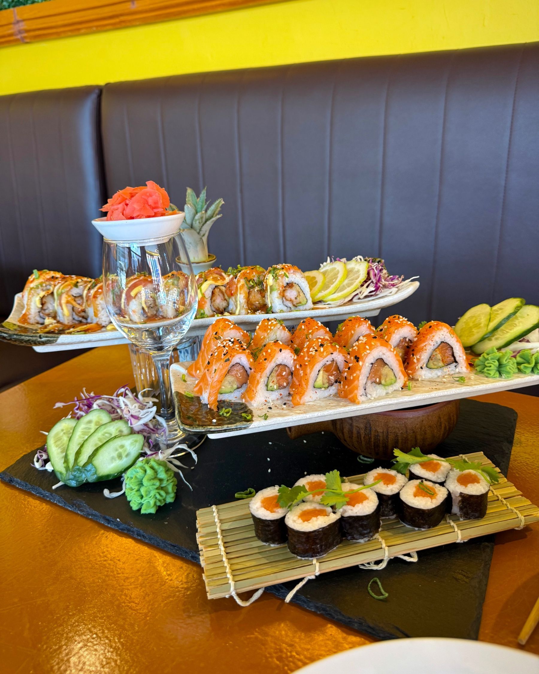New-style salmon roses alongside other sushi dishes prepared by Chef JC at Aiko Sushi Plus.