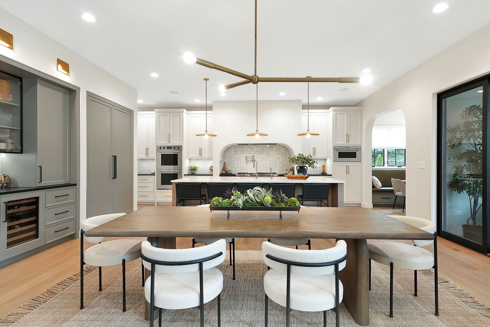 A dining room table and chairs in a kitchen.