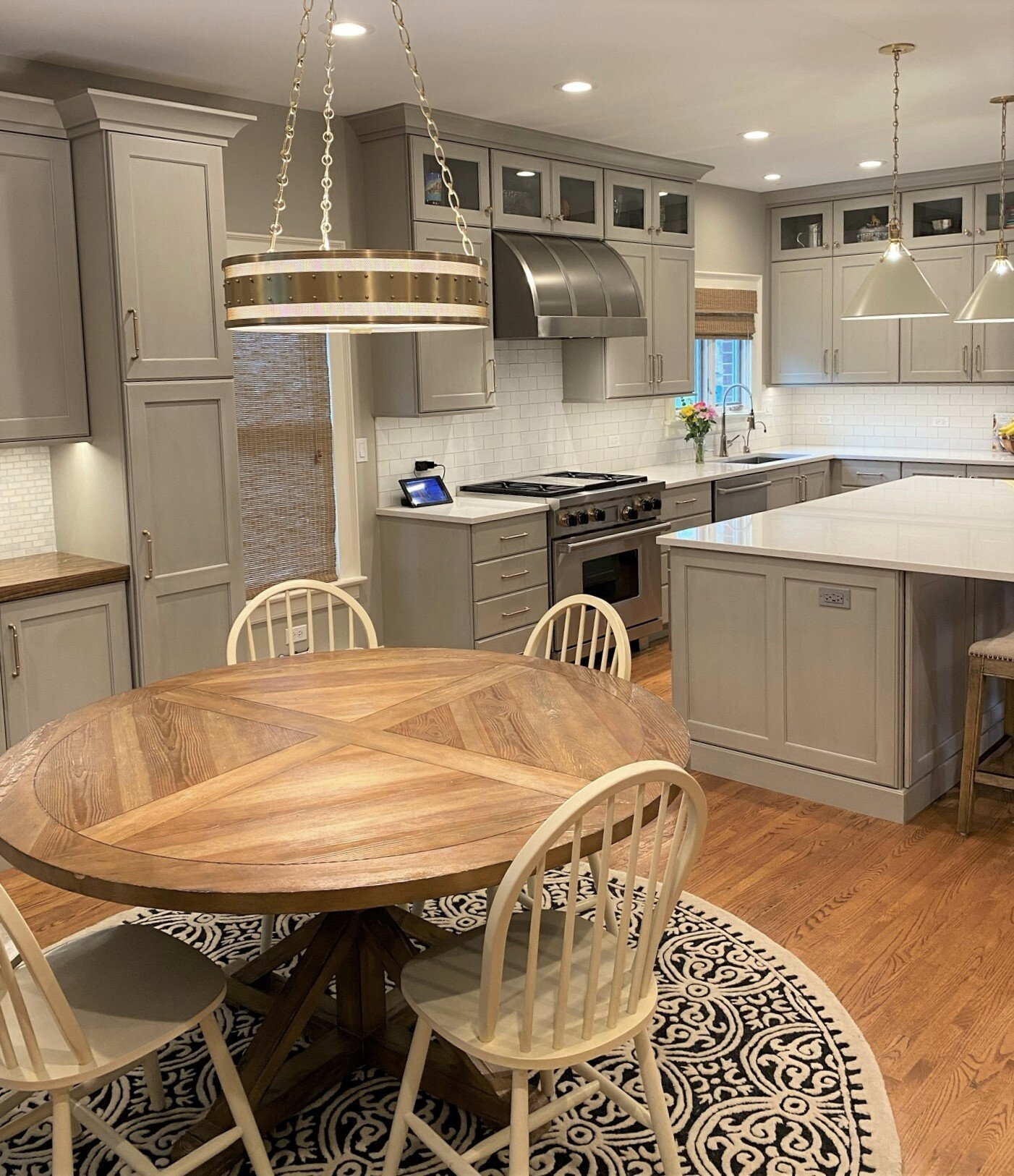 A kitchen with a round wooden table and chairs.