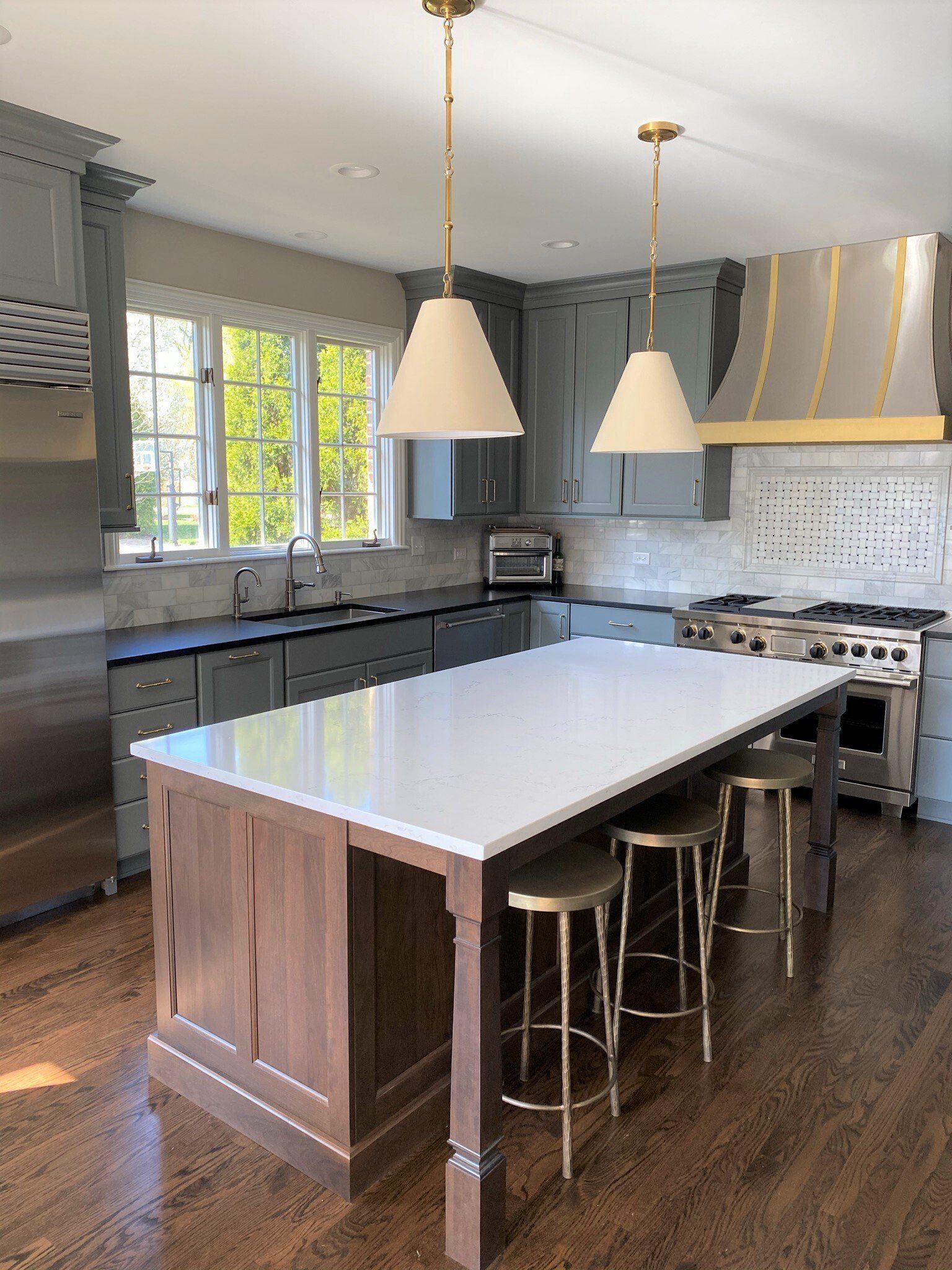 A kitchen with a large island and stools