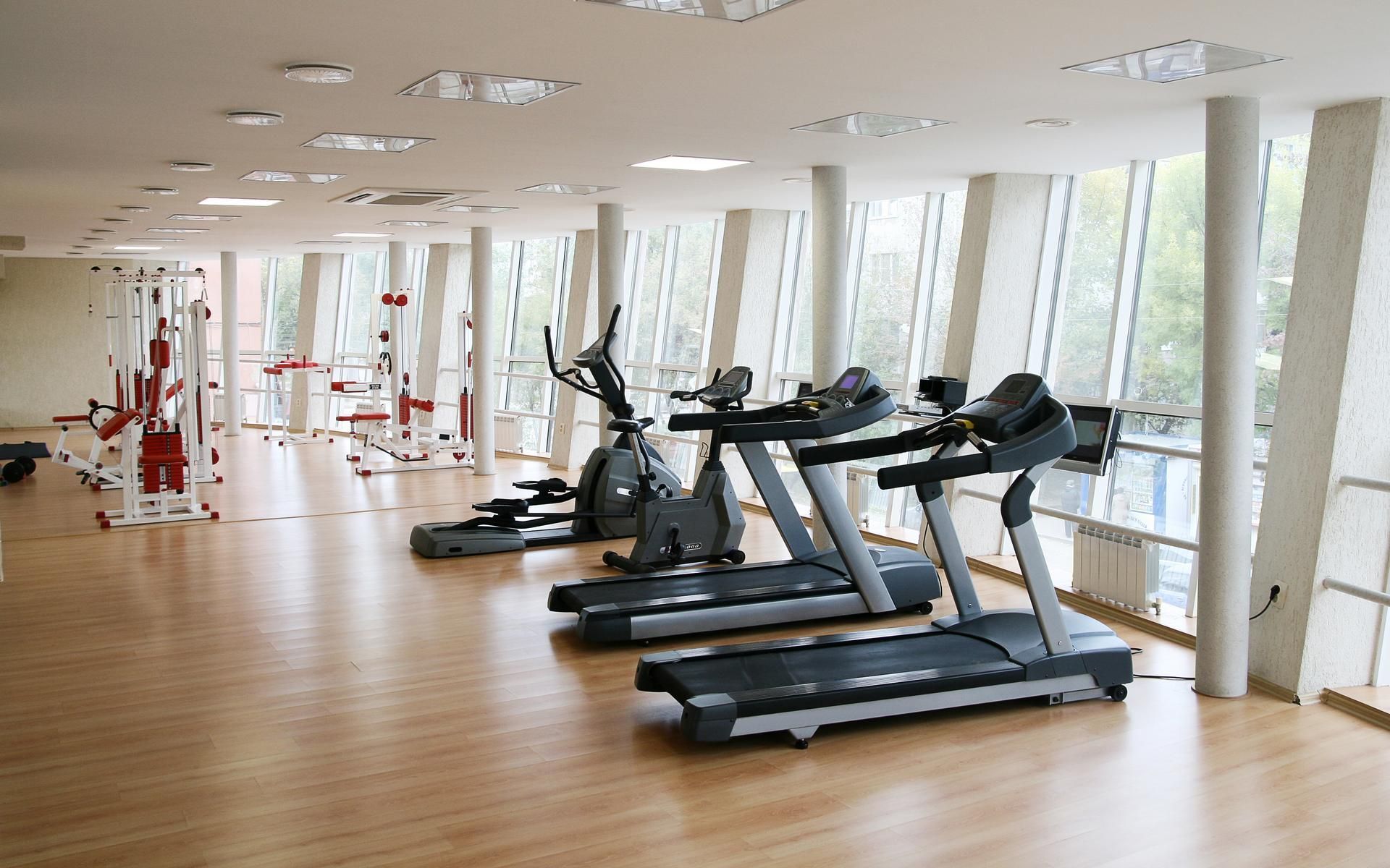 A gym filled with treadmills and exercise bikes.