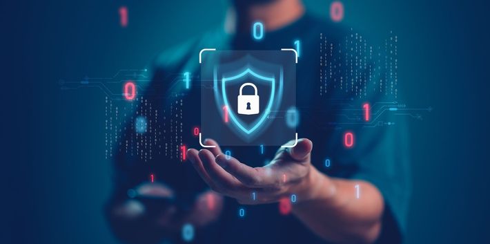 a man is holding a shield with a padlock on it in his hands