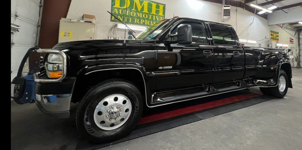 Black stretch pickup limousine on a display platform in a showroom