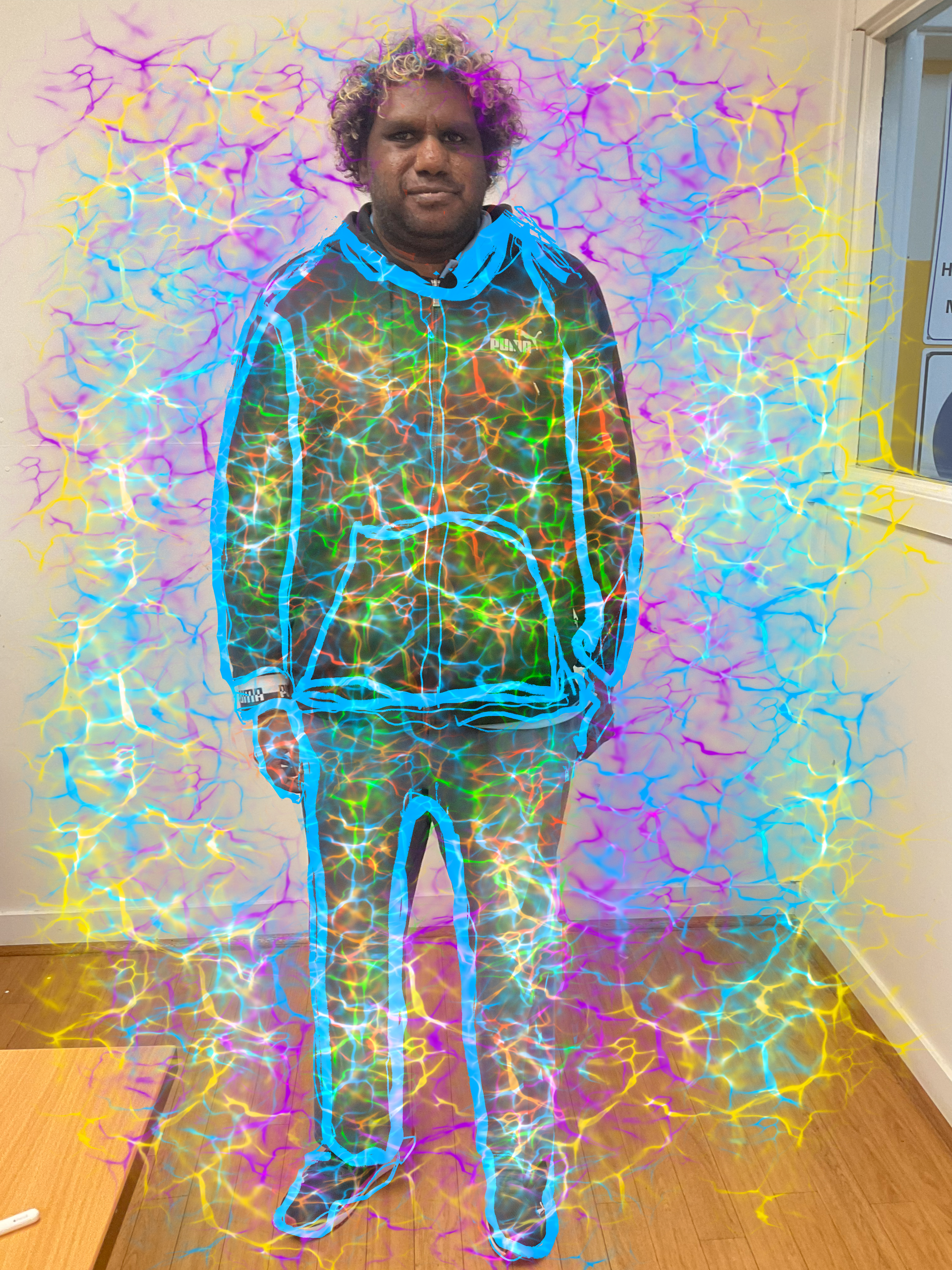 A man is standing in a room with a colorful background.
