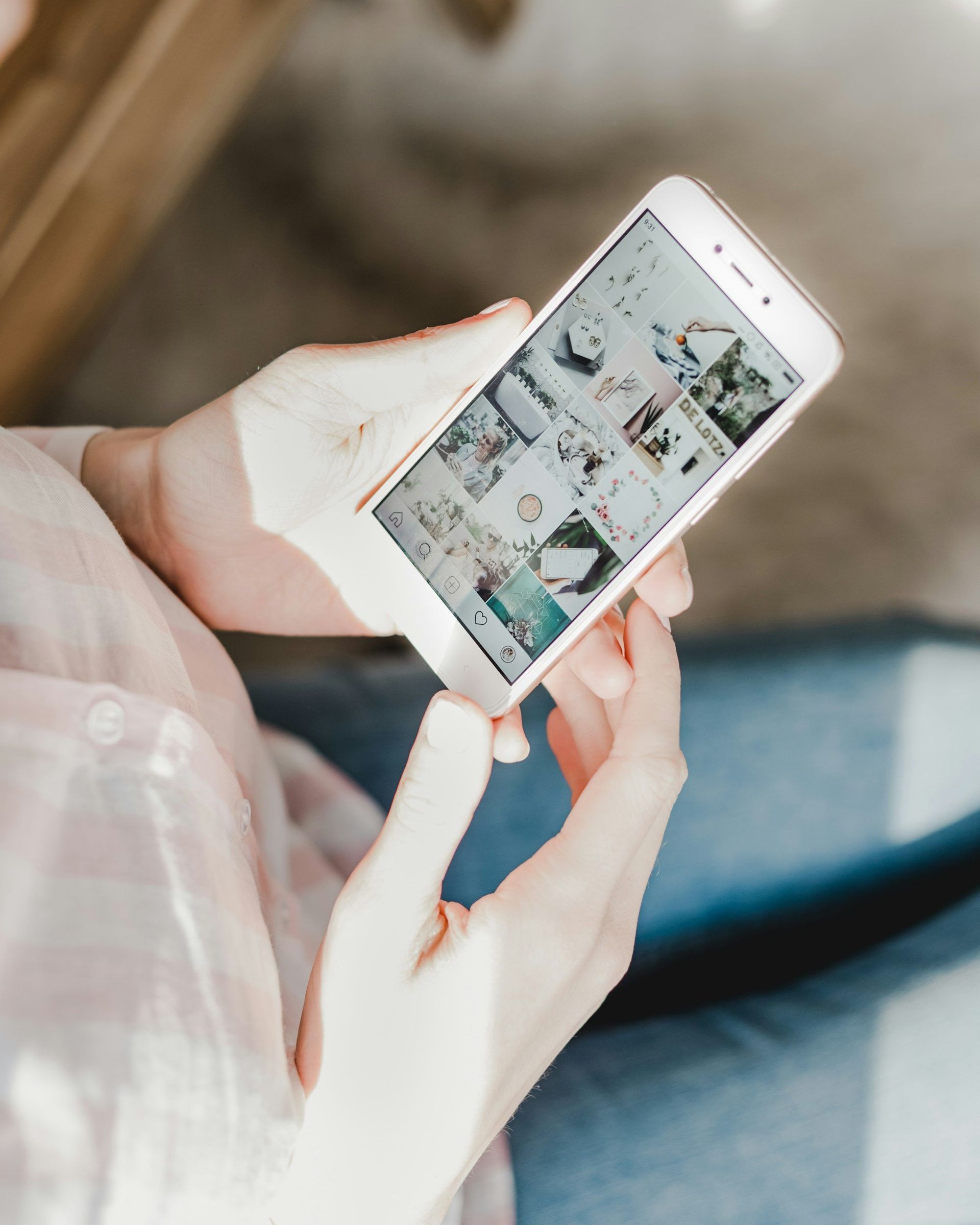 A woman is holding a cell phone in her hands