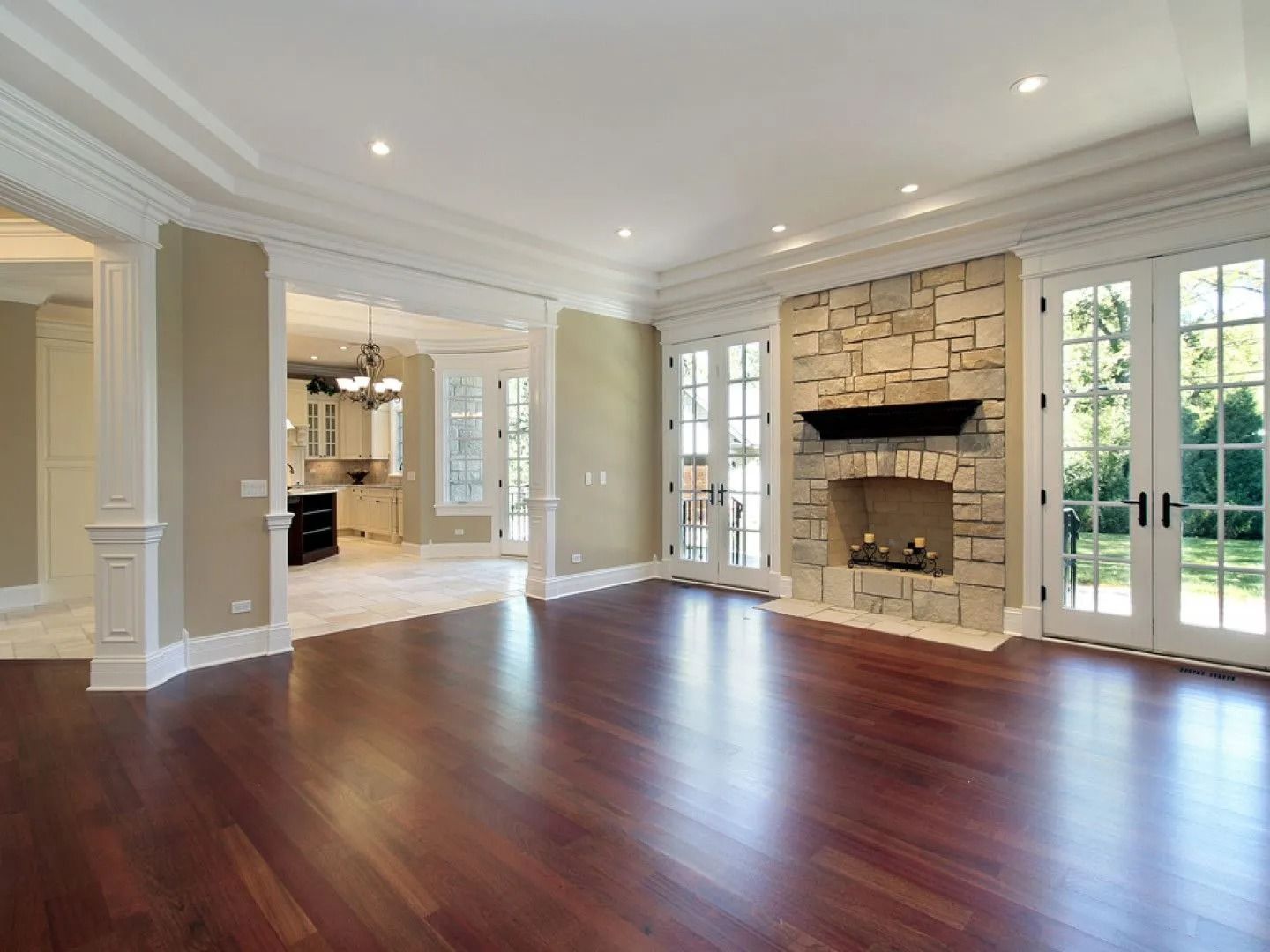 Wooden floor with a small potted plant on a rolled mat in the corner.