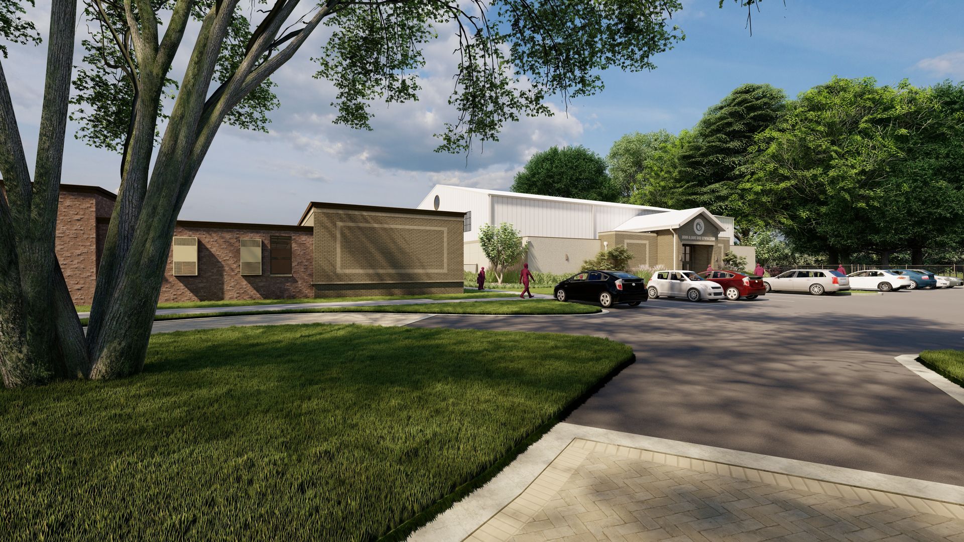 Exterior view of a building with a parking lot and trees. Cars are parked. Green grass and blue sky are visible.