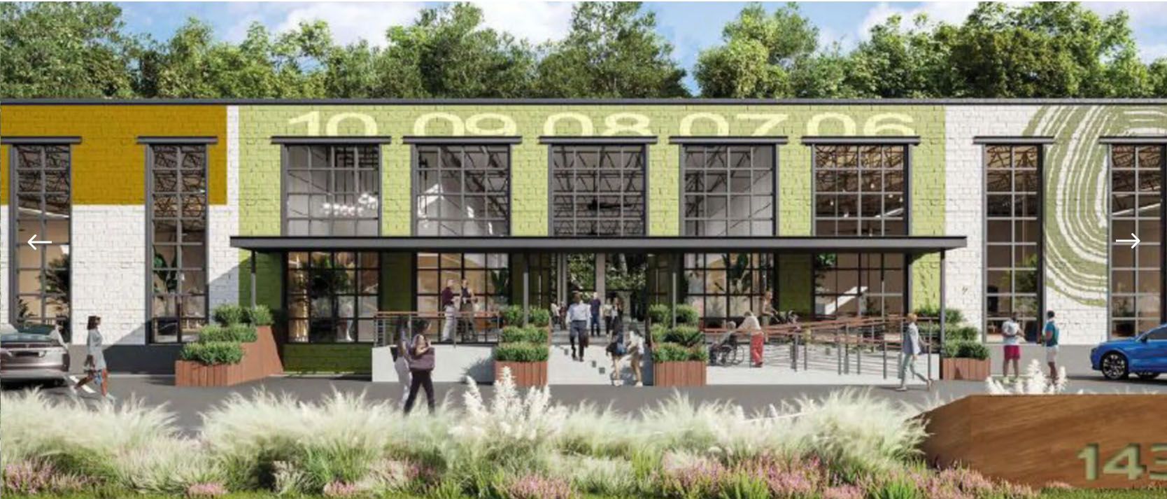 Building exterior with large windows, people entering, green and yellow color scheme, and ornamental plants.