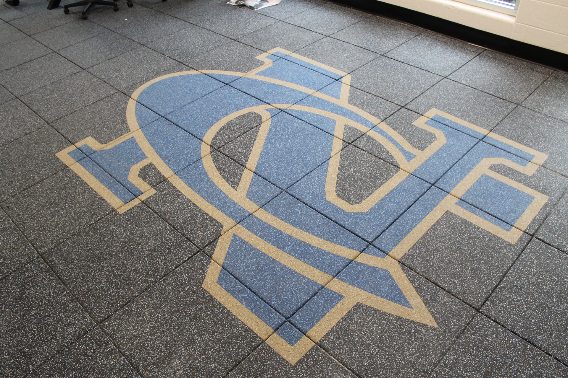Floor with University of North Carolina logo in blue and gold.