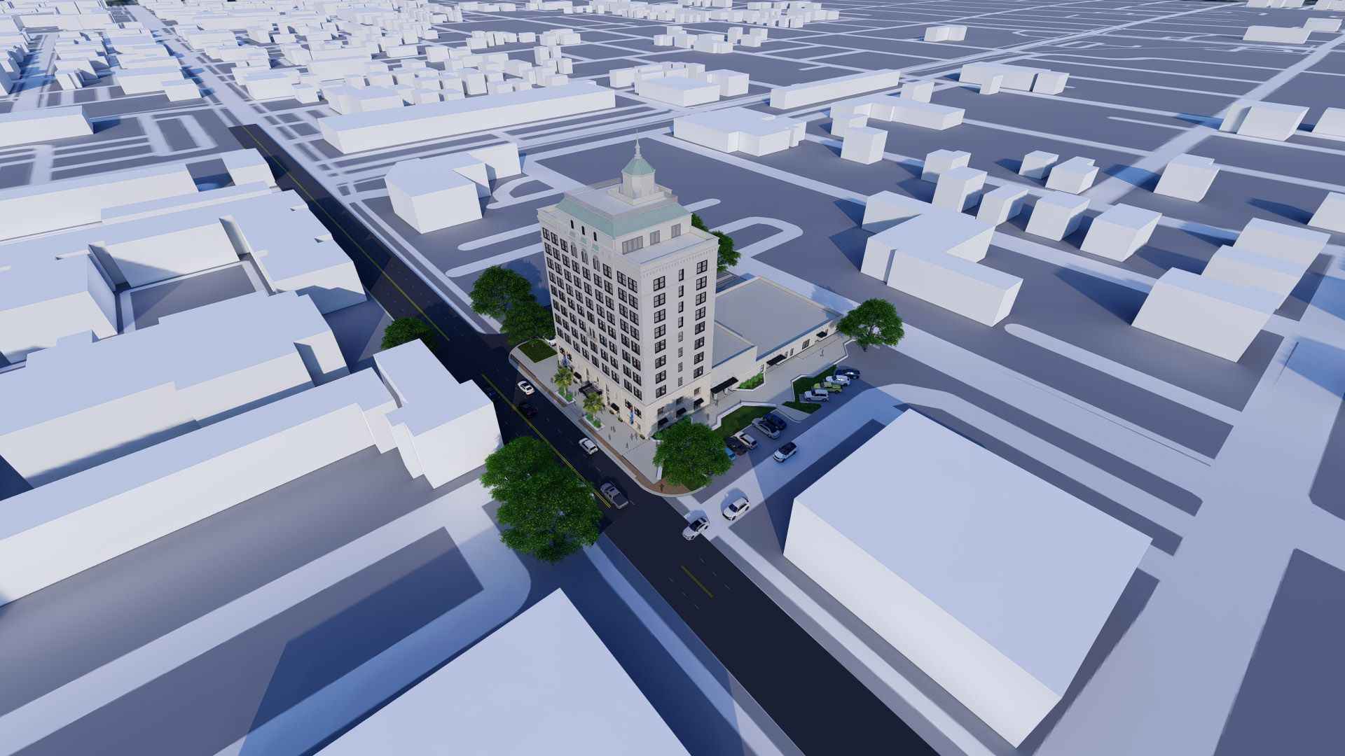 Bird's-eye view of a beige high-rise building on a city street, surrounded by other buildings and trees.