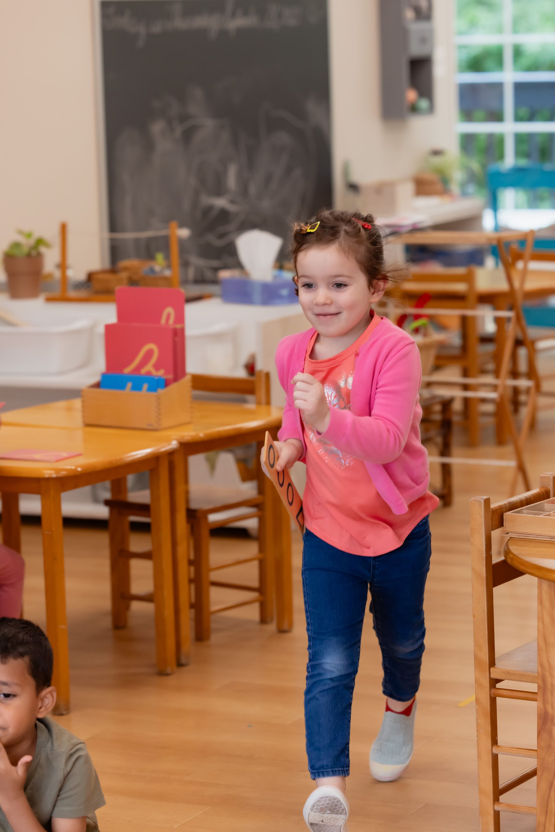 Montessori child walking in the classroom