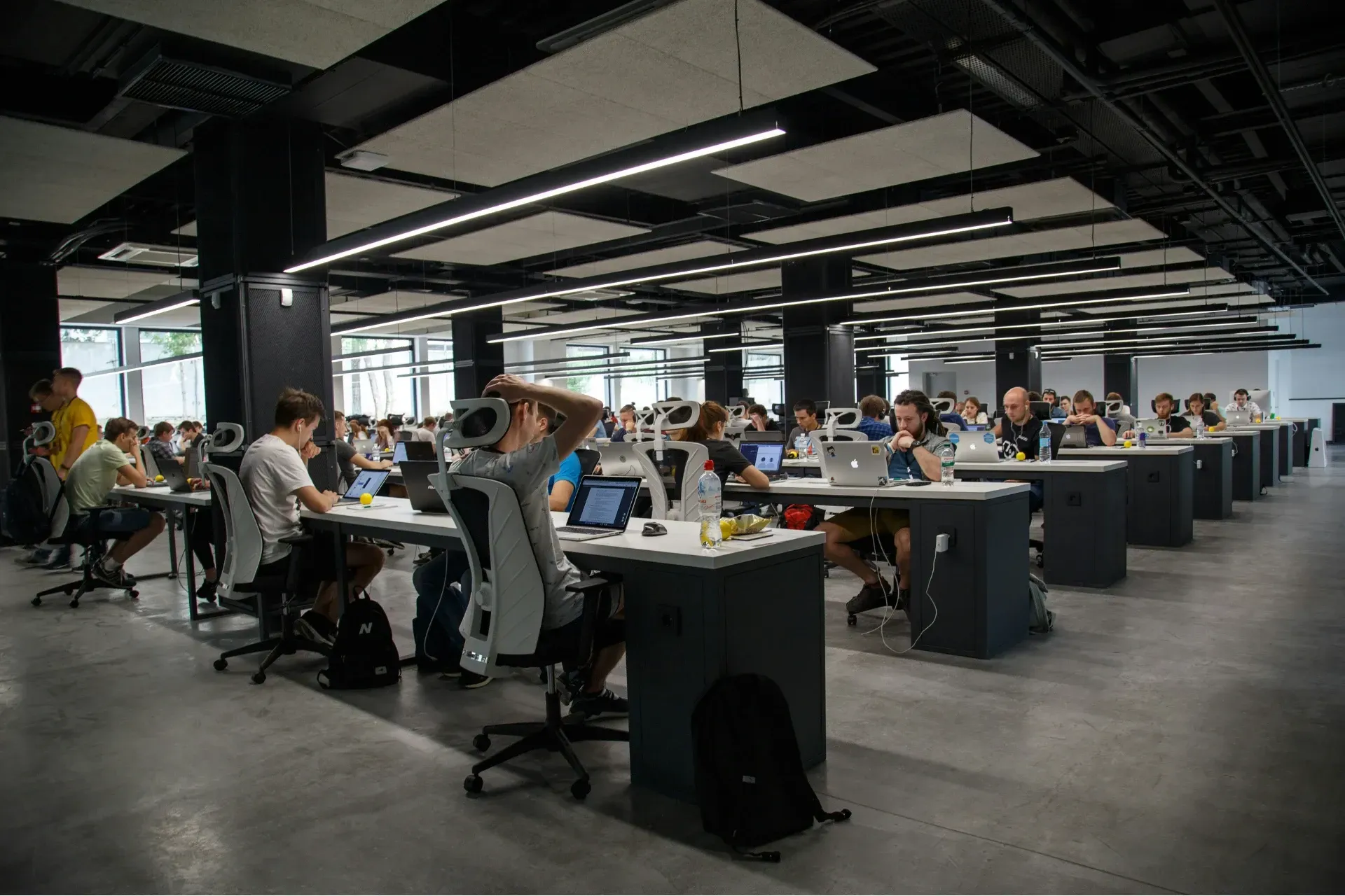 The interior of a workplace with many employees at their desks