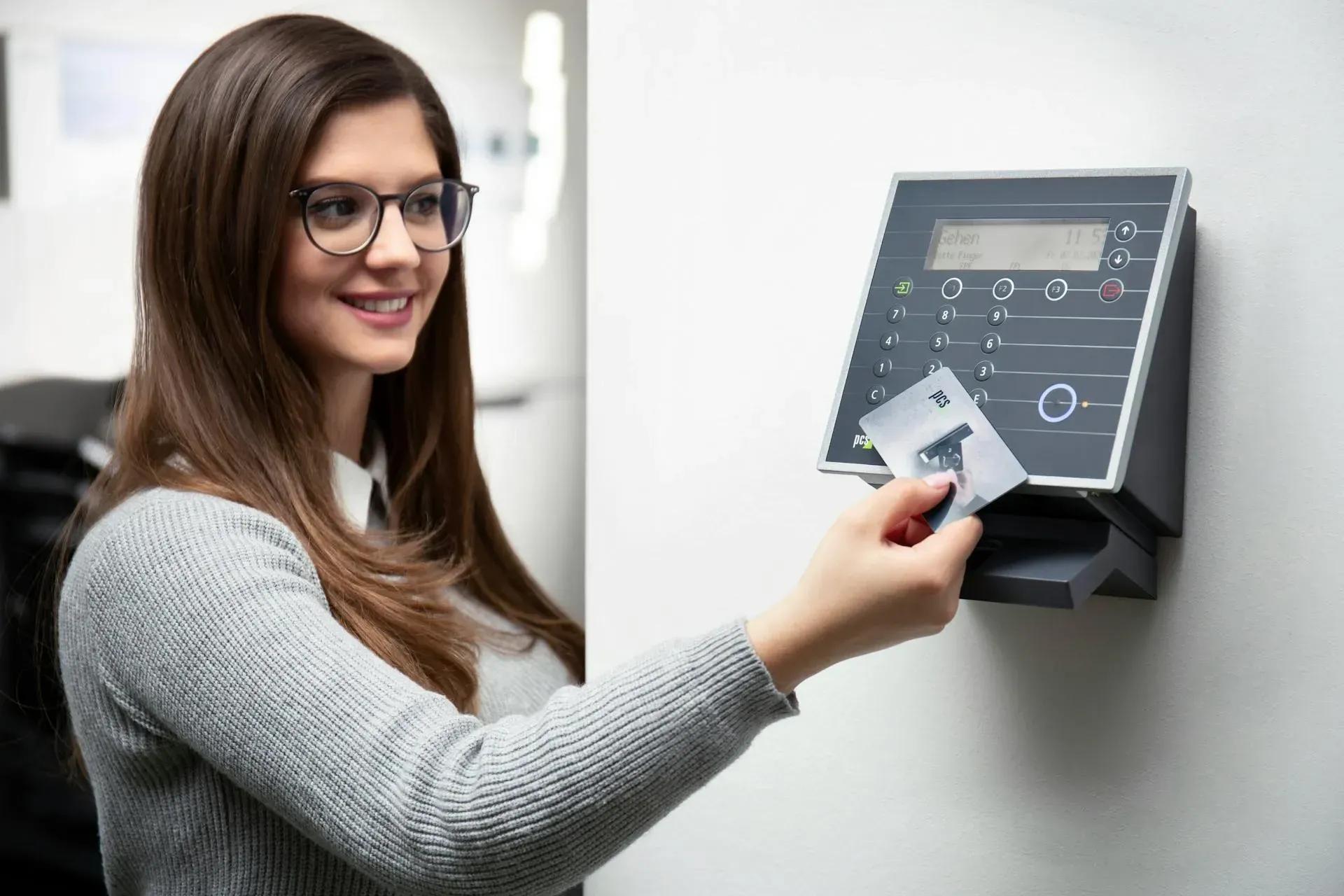 A female employee scanning her company ID to get entry access