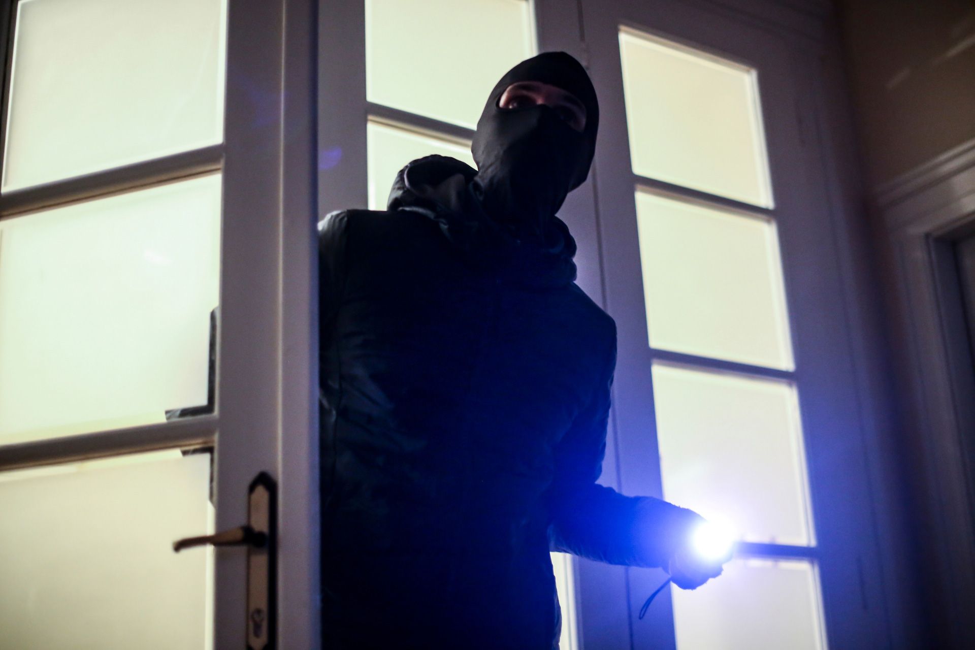 Burglar breaking into a home