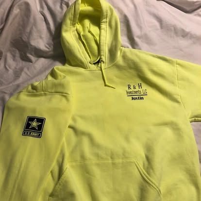A neon yellow hooded sweatshirt featuring an 