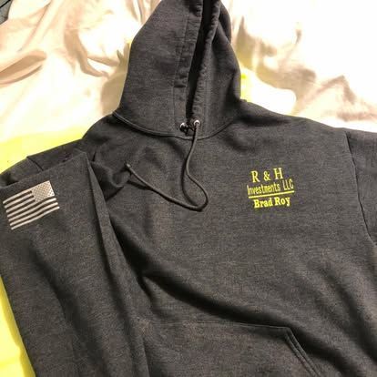 A charcoal gray hooded sweatshirt with an American flag on the sleeve and 