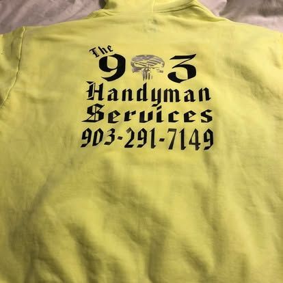 A neon yellow hooded sweatshirt printed with black gothic-style text: 