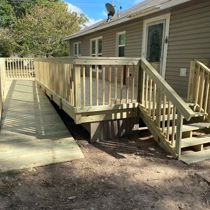 A wooden deck attached to a house features a wheelchair ramp on one side and a staircase on the other.