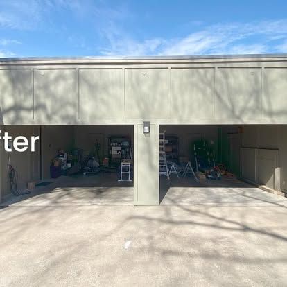 A garage exterior with no doors, showing a cluttered interior, two concrete bays, and light beige paneling above.