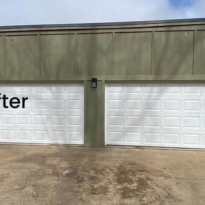Two white panel garage doors set under a sage-green exterior wall, with the word 
