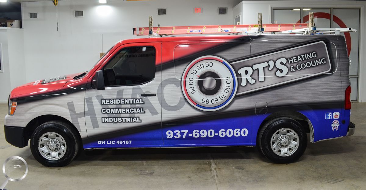 Silver and blue RTS tow truck with red accents and phone number parked indoors