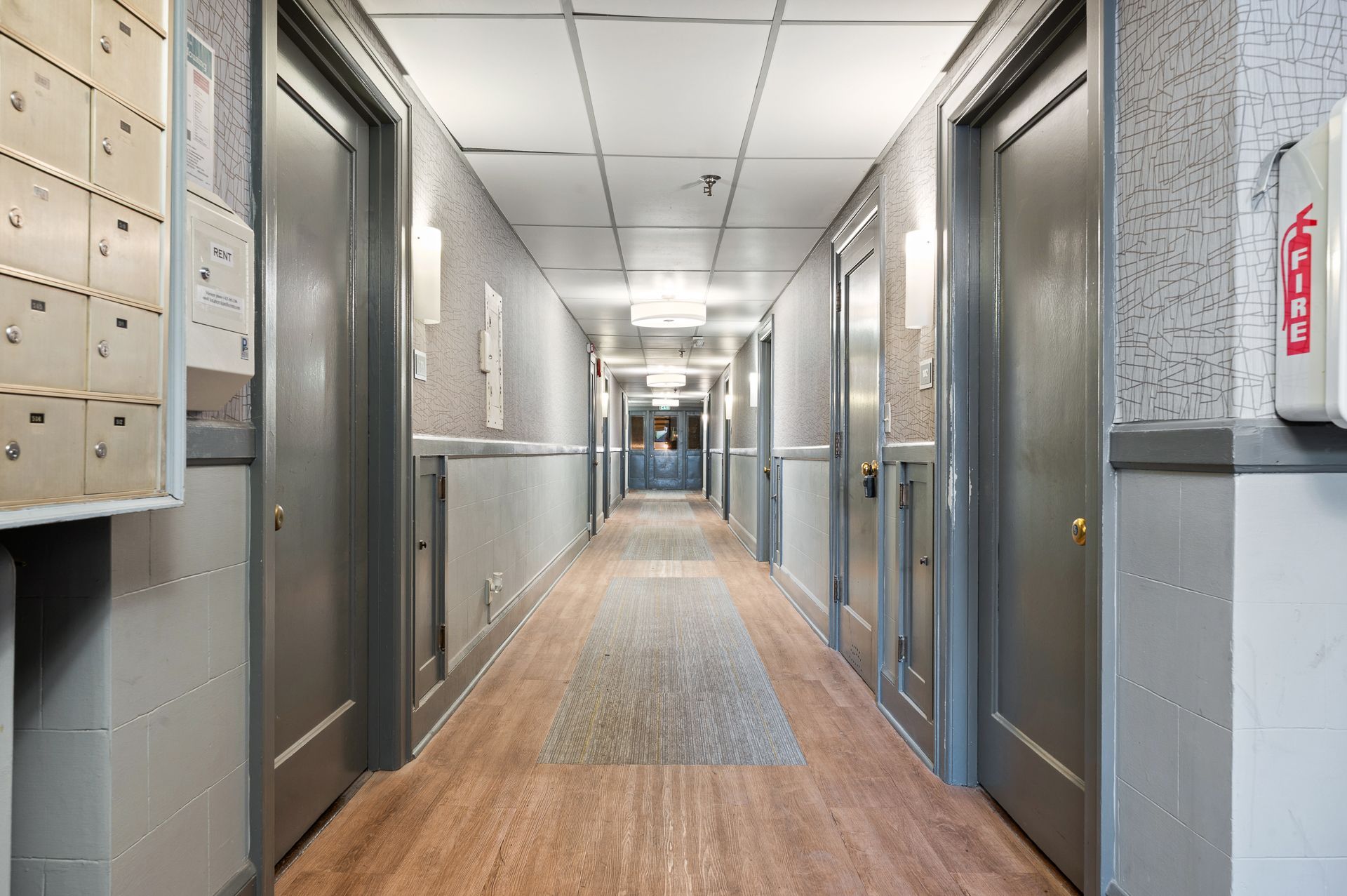Photo of a hallway with community mailboxes at the foreground of the photo