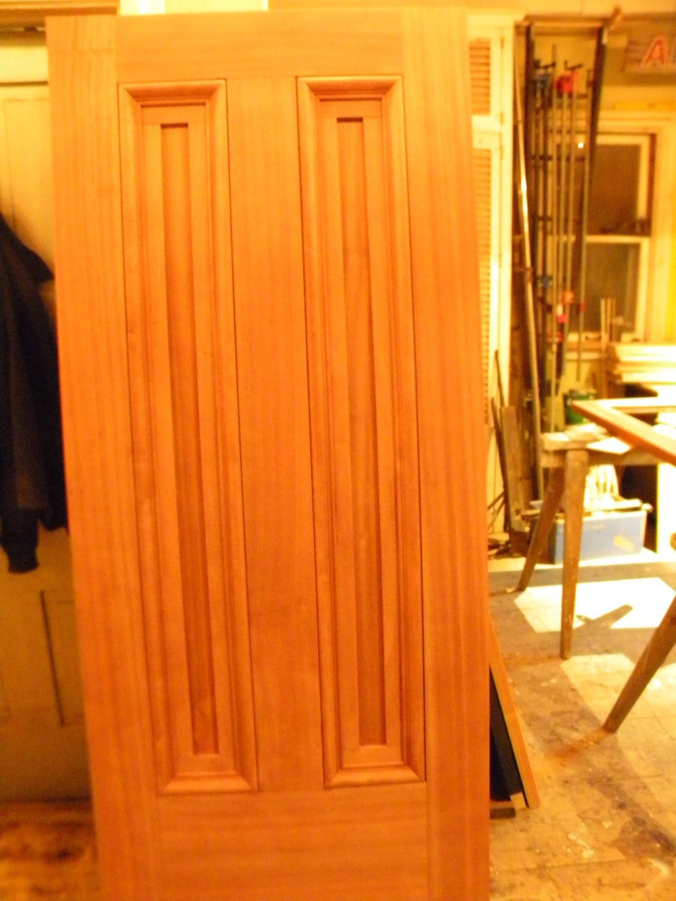 a wooden door is sitting on a wooden floor in a room